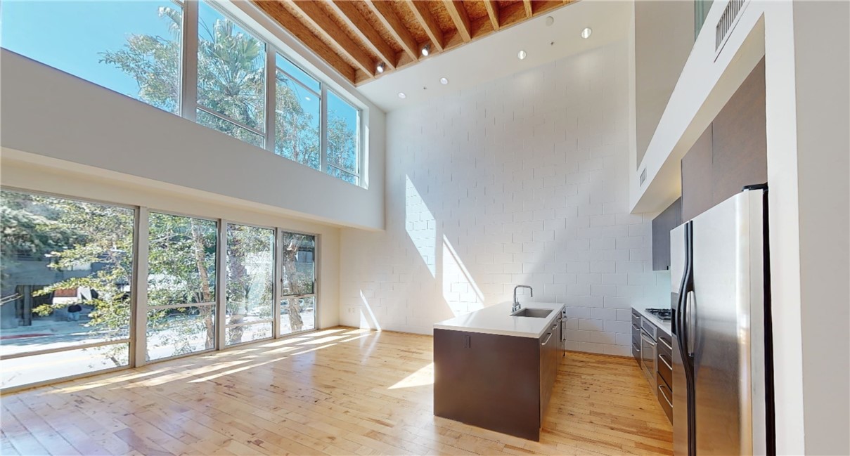 We are excited to welcome you to a rare gem in the heart of Hollywood Hills’ sought-after Cahuenga Corridor—an office, residential, live/work loft blending high modernism with unmatched functionality. Zoned for commercial use (LAC2) and/or Residential, this stunningly designed showpiece is the ultimate space for creators, innovators, and professionals seeking a stylish yet practical environment to live, work, and thrive.
Step inside and be captivated by the bold design featuring towering 18-foot ceilings, expansive floor-to-ceiling windows, and striking walls designed to showcase art or make your brand statement. The open-concept layout is thoughtfully crafted across multiple levels, providing versatility for mixed-use purposes, while the floor-to-ceiling windows immerse you in natural light. Dual balconies offer breathtaking views of the Hollywood Hills, creating the perfect retreat from the city buzz.
The sleek, modern kitchen is equipped with premium stainless steel appliances, while the spa-inspired bathrooms boast designer finishes, elegant fixtures, and luxurious details. The expansive primary suite or executive office has its own private level, complete with a soaking tub, an in suite bathroom, and a personal balcony—your sanctuary in the sky.
This exclusive, gated micro-community offers exceptional amenities, including two BBQ areas with lounge seating and picnic spots for hosting clients or unwinding after a productive day. Free Valet parking for guests ensures convenience, and additional parking arrangements are available nearby for employees or extra vehicles.
Located just moments from iconic destinations like the Hollywood Bowl, Universal Studios, Runyon Canyon, and Ventura Boulevard’s vibrant shopping and dining scene, this property offers the best of Hollywood and Studio City. Whether you’re envisioning a creative workspace, production headquarters, design studio, or a modern hillside retreat, the possibilities are infinite.
Don’t miss your chance to own this extraordinary property that redefines the art of the modern work environment. Contact us today for a private showing and start your next chapter in style.
*Residential, Commercial & SBA Financing Available!
**VIRTUAL WALK-THROUGH LINK, BROCHURE & PROPERTY WEBSITE BELOW**
