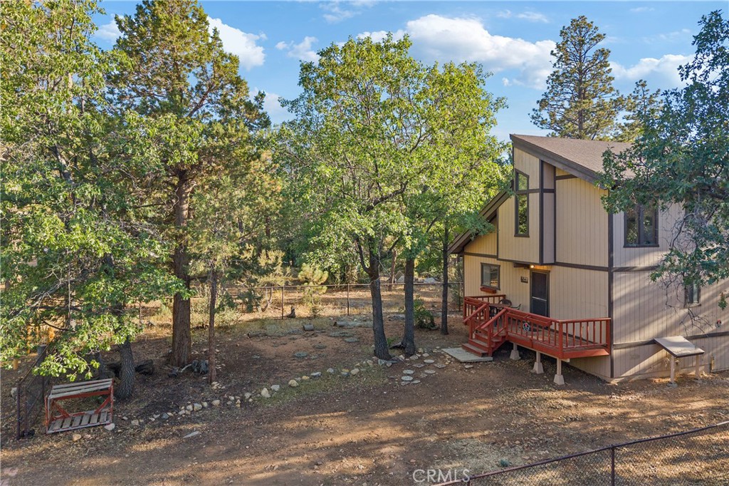 Cradled by the towering oaks and pines at the edge of the National Forest, this mountain retreat feels like a gateway to another world. Trails for hiking and biking wind straight from your doorstep into endless wilderness, where time drifts at the pace of whispering pines and distant birdsong. Inside, soaring vaulted ceilings and picture windows capture the forest in shifting light--morning sun spilling across the open floor plan, twilight casting a golden glow. 2 bedrooms, 2 full baths, and a cozy loft offer intimate spaces for rest, each touched by the serenity of its surroundings. Front and back decks invite you to linger, whether watching the sky blush at sunset or tracing constellations on crisp, starlit nights. With a mudroom, ample storage, forced-air heating, and more, this home blends comfort with the quiet magic of the mountains--a place to both lose yourself and find yourself again.