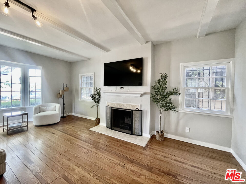 Absolutely stunning and newly remodeled while preserving its original charm, this spacious and bright downstairs unit in duplex is a must-see! The formal living room is full of character with a wood-burning fireplace and picturesque bay window that allows for abundant natural light. The brand new kitchen has a breakfast bar and opens up to the formal dining room. Adjacent to kitchen is the laundry room with extra pantry closet and direct access to private back patio, providing ample outdoor living space, perfect for relaxing or entertaining. Both bedrooms, including the primary suite, are spacious with stylishly renovated en-suite bathrooms and ample closet space. Perfectly situated in PicFair Village near trendy cafes and offering convenient access to major shopping and dining destinations--The Grove and Farmer's Market Mid-City and the 10 Freeway. Available immediately, can also be fully or partially furnished. **Offering $500 credit per month, inquire for more details.