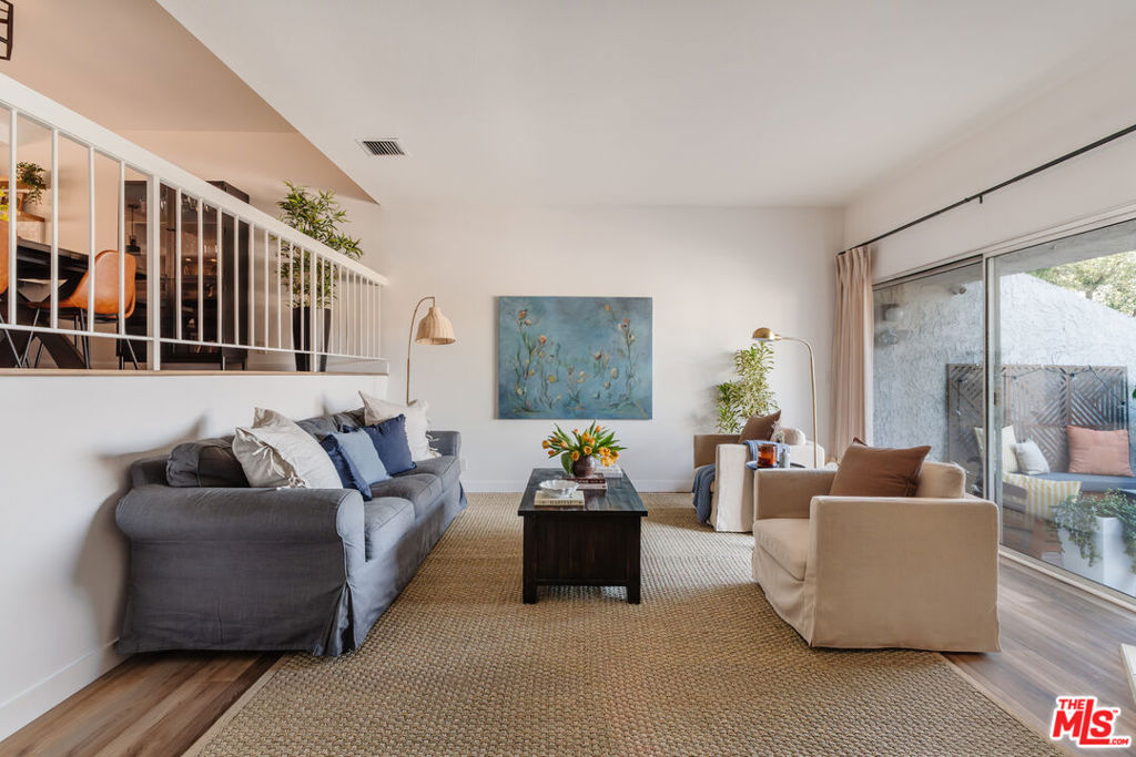 A reimagined 2 bed, 2.5 bath townhome in the gated Tarzana Villas blending scale, style, and ease. Elevated from the street for a sense of privacy, the living room rises with vaulted ceilings, a fireplace, and sliding glass doors opening to a walled, private patio for effortless indoor/outdoor flow. A large private direct-access 2-car garage with laundry and storage provides a blend of practicality and comfort. The open layout kitchen has been reimagined with design-forward finishes and is generous in scale featuring a breakfast bar, walk-in pantry, wine fridge, newer appliances, and conveniently opens to the dining space. A powder bath with Portola Paint lime wash walls adds a refined, design-forward touch. Upstairs, the oversized primary suite offers a double vanity, a dedicated makeup station, and walk-in closet. A spacious guest bedroom with 10' ceilings features a balcony and walk-in closet and sits next to a beautifully redesigned full bath. Additional highlights include luxury waterproof SPC flooring throughout, remodeled bathrooms with Portola Paint lime wash walls, a Nest thermostat, SimpliSafe security & camera, and smart leak detection.Community amenities include a heated pool + spa, tennis court, clubhouse, and sauna. Minutes to the best shops & dining on Ventura Blvd as well as the Tarzana Village Walk with a new Trader Joe's, Sephora, Nordstrom Rack, and LA Fitness. Close to beautiful hiking trails, 35 minutes to Malibu or take a scenic drive up to Ojai or Santa Barbara for a quick weekend getaway. Conveniently close to the 101 and 405 making a commute a breeze. HOA covers earthquake insurance, water, sewer, and trash.
