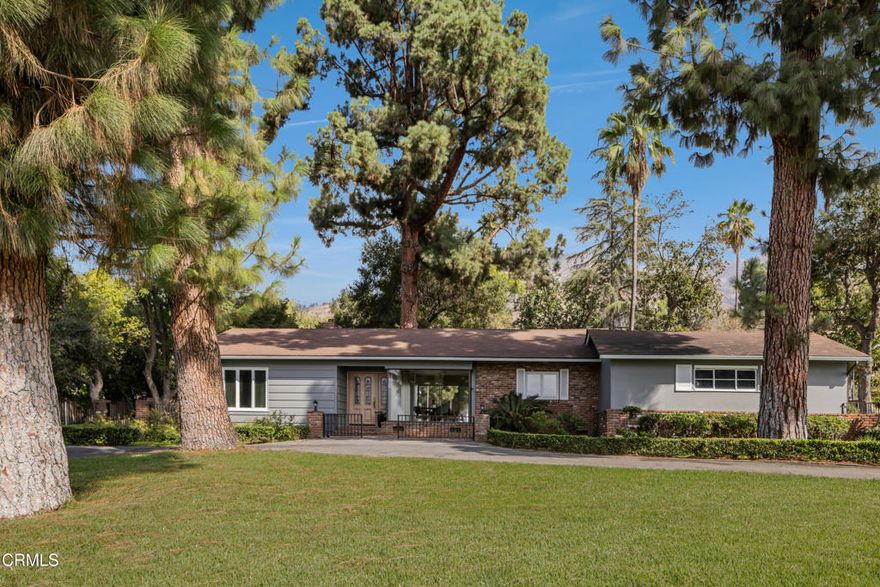 Live Among the Evergreens with Huge Pine Trees Surrounding This Wonderful Home! Nestled in the highly desirable Kinneloa Mesa neighborhood of Pasadena and just moments from Eaton Canyon Golf Course, this property offers a serene setting with the added bonus of beautiful city lights views. The home features 2 bedrooms and 2 baths with 1,375 square feet of living space on an expansive 23,236 square foot lot. The kitchen and bathrooms have been updated, while original charm remains throughout with hardwood floors (under carpet), open beam ceilings, crown molding, recessed lighting, French doors, built-in shelves, 2 fireplaces, and a separate dining room with a large picture window. Outside, enjoy a large circular driveway with RV parking, a 2-car garage with laundry hookups, and multiple patios including a quaint front porch and a covered rear patio. Brickwork accents the planters, walkways, and patio spaces, complemented by mature landscaping with a large magnolia tree, avocado trees, and more.This exceptional property offers endless potential - whether adding an ADU, pool, or expanding the existing home substantially. In fact, conceptual plans already exist for a stunning two-story residence of approximately 5,000 square feet with a pool, providing a glimpse of what could be created in this remarkable setting.