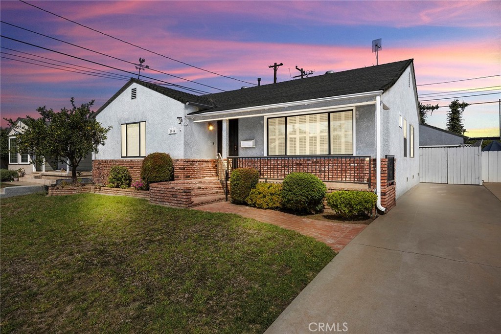 *** Here's an opportunity for your dream to become a reality ***This charming home can be yours in time for you to enjoy with friends and family for the holidays! The front entrance features a red brick façade and a wrought iron railing leading to a covered entry, creating a warm and timeless curb design. Spacious and bright living room with gleaming hardwood floors and plantation shutters. Living room opens directly to the formal dining area, making family meals and gatherings a breeze with the kitchen just steps away for added convenience. The kitchen with light gray cabinetry is accented by sleek silver hardware. Corian countertops with white appliances, including a stove, microwave, dishwasher, and a large window over the sink brings in natural light. Inside laundry room with built-in storage and direct access to the backyard. Flexible living space with a charming brick fireplace and built-in shelving, offering endless possibilities from a relaxing den to a cozy family room, home office, or 4th bedroom. It has a sliding glass door that opens directly to the backyard, creating an easy indoor-outdoor flow. First and second bedroom located at the front with hardwood floor, and hallway bathroom features both a relaxing soaking tub and a separate glass-enclosed walk-in shower. Third bedroom at the rear of the home is a spacious private master ensuite offering comfort and versatility. Ensuite has a bathroom with a tiled walk-in shower, ample oak cabinetry, and a wide vanity with bright overhead lighting. Ideal as a luxurious retreat or a comfortable mother-in-law suite. It has a sliding glass door and private ramp leading to the covered patio/backyard. The backyard offers a low maintenance outdoor space with mature landscaping, decorative brick-trimmed walkways, flexibility for entertaining, gardening, or creating your own retreat. This home has been virtually staged to illustrate its potential. Live comfortably in this wonderful neighborhood and is conveniently located close to Lakewood mall, shopping, dining, entertainment, great schools, parks, major transit, golf, the LB Airport, and easy access to freeways, don’t miss your opportunity to own this excellent home in the heart of Lakewood.