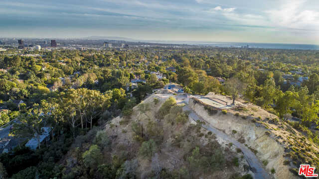 Amazing Brentwood development opportunity situated on two private parcels, approximately three acres combined with 360 degree panoramic views from the Getty center, to downtown LA, to the ocean. Come remodel the existing home or build new. This is a once in a lifetime opportunity not to be missed, you won't come across another property like this. Full property development analysis prepared by Crest Real Estate, architectural survey by PBLA Engineering, and geo and soils engineering report by Irvine Geo. 594 N Tigertail (APN: 4494-001-009) is being sold with this property.