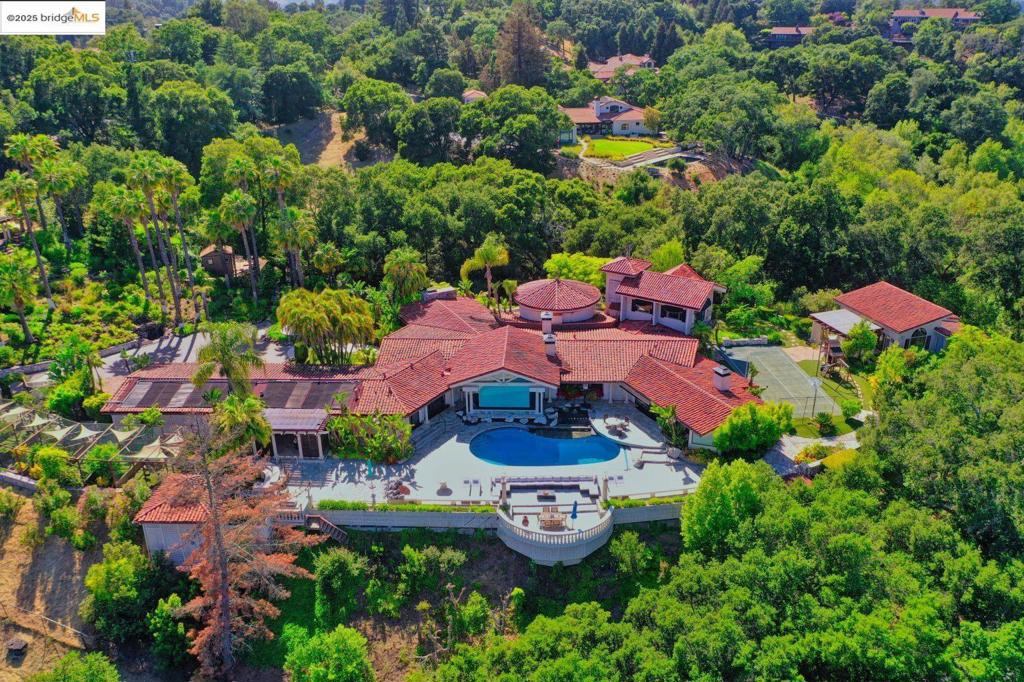 A once-in-a-lifetime opportunity to own a world-class Mediterranean mansion—an ultra-private, resort-style sanctuary in Upper Happy Valley, one of the Bay Area’s most exclusive enclaves. Designed, built, and previously owned by internationally acclaimed artist and designer Henry Conversano—renowned for ultra-luxury resorts, iconic casinos, and bespoke residences for Donald Trump and other elite clientele—this architectural masterpiece blends timeless artistry with modern sophistication. Thoughtfully renovated around the 2000s, it showcases exceptional craftsmanship and museum-quality finishes throughout. Set behind a private gate at the end of a 200-ft driveway on ~3.2 acres, the 8,282± sq ft estate features a dramatic rotunda hall ideal for private galas and intimate gatherings. Polished marble floors flow through the expansive common areas, and picture windows frame breathtaking views of Mt. Diablo, filling the home with natural light. Masterfully landscaped to evoke the elegance of a diamond necklace, the resort-inspired grounds include lush gardens, a 50-ft waterfall, sculpted fountains, a tranquil aviary, outdoor kitchen, fire pit, and multiple terraces for seamless indoor-outdoor living. A rare legacy estate for the most discerning buyer. Views: Ridge