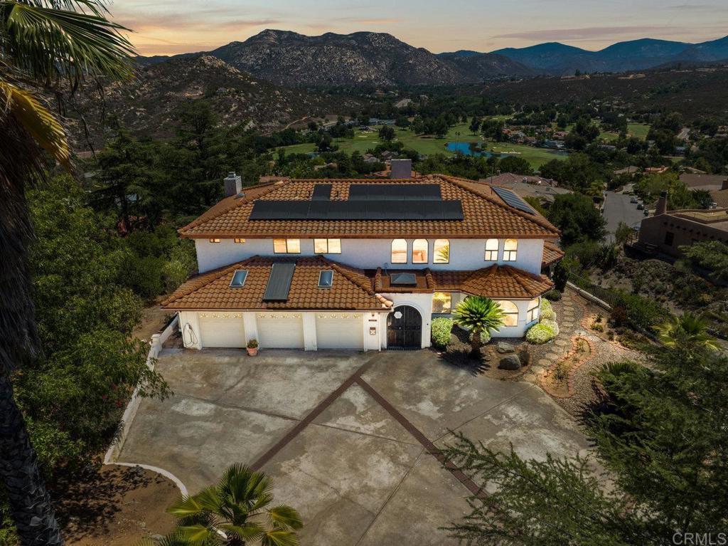 Situated atop the Prestigious San Diego Country Estates, this custom built 3,859 sqft home is one of a kind. 4 bedrooms, 4 bathrooms, 2 family rooms, 2 dining rooms, hidden wine cellar, waterfall entry, sand cast art wall from renowned San Diego Artist and Architectural engineer of the San Diego Zoo Charles Faust, 3 car garage, solar w/ 3 Tesla batteries and EV hookups, elevator/lift for those who wish to skip the stairs, and breathtaking views from every window in the entire home. Drive your golfcart to your tee time or watch the golfers from the panoramic views in your backyard while watching the east facing sunrise. Full privacy at the top of the mountain and no neighbors encroaching your privacy or views. The property is just over half an acre (.53) at 23,086 sqft with lots of driveway parking. MAJOR VIEWS in this Master Plan Community.