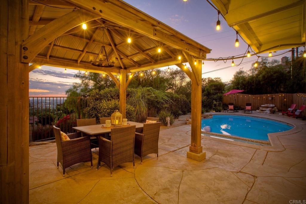 Experience an exceptional find in Vista’s coveted Elevado Hills where panoramic views, a sparkling pool, and nearly a half-acre of privacy await! This 4-bedroom, 3-full bath retreat offers 2,724 sq. ft. of versatile living space designed for comfort, elegance, and ease. Perched on a private road, the home showcases sweeping views that stretch toward the ocean by day and transform into a dazzling city-light backdrop by night. Inside, expansive windows showcase the home with natural light, framing the views from nearly every room. The updated kitchen features brand-new granite countertops, stainless steel appliances, a farmhouse sink perfectly positioned to capture the scenery, and a walk-in pantry for everyday convenience. On the main floor enjoy a large bedroom and full bath with no stairs - this home adapts beautifully to multigenerational living, guests or an office along with abundant views. Upstairs three bedrooms and two full baths await the coastal cool breezes and expansive views. The primary suite is a sizeable private escape, complete with breathtaking views, an en-suite bath, two walk-in closets, and added bonus flex space. Step through the double doors off of the family room and into your own resort-style paradise. Lounge by the sparkling pool and spa, entertain and dine under the stars. The fully fenced property also features RV parking, 2-car garage, a chicken coop and ample space for a future ADU—offering both lifestyle and investment potential. Modern upgrades include 30 fully owned solar panels, a remote-controlled electric driveway gate, newer central heating and AC and the freedom of no HOA. Though you’ll feel worlds away in this private oasis, everyday conveniences—Starbucks, shopping, restaurants and breweries—are minutes away! Whether hosting sunset gatherings, relaxing poolside, or savoring the view from your kitchen window, this Elevado Hills residence offers a rare blend of luxury, sustainability, and privacy—your very own slice of paradise in North County San Diego.