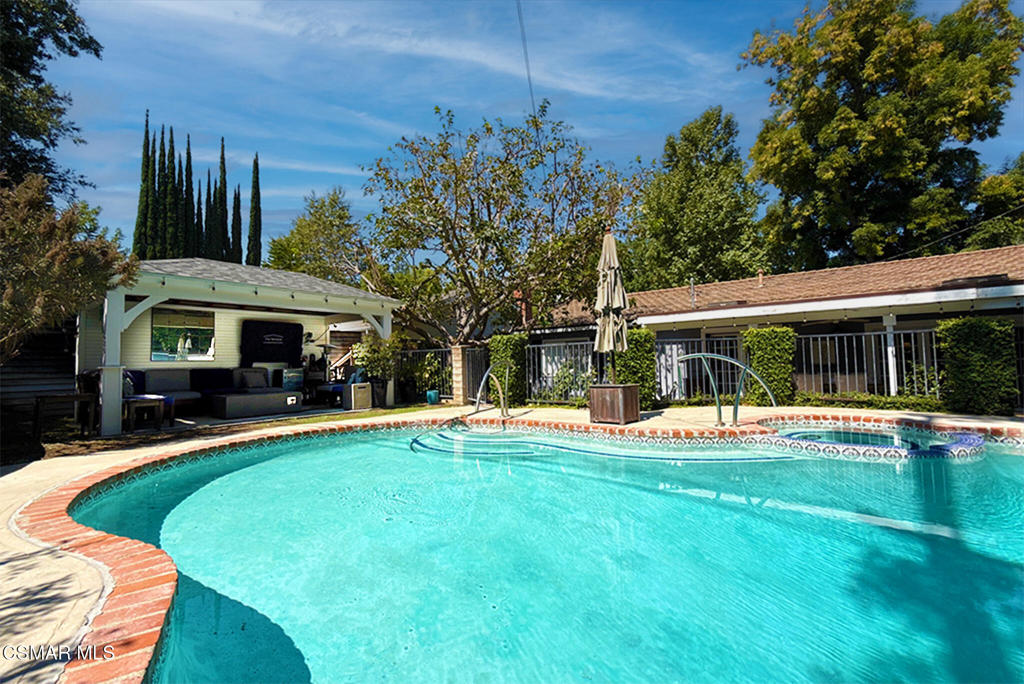 An amazing opportunity to lease this fully furnished 4-bedroom, single-story pool home south of the boulevard, filled with timeless charm and character. Flexible lease terms make it easy to move right in and enjoy everything this beautiful property has to offer. Inside, rich wood floors, library-style built-in bookshelves, and elegant French doors create a warm and inviting atmosphere. The kitchen opens seamlessly to the formal dining area, which flows into the living room, and beyond--double French doors reveal a sprawling patio perfect for outdoor dining and entertaining. The backyard is a true entertainer's dream. An upper-level cabana with tongue-and-groove detailing, a TV, and a cozy firepit overlooks the sparkling pool and spa, creating the ultimate retreat. Tucked away on a private, quiet cul-de-sac south of the boulevard, this home offers serenity while still being just minutes from restaurants, shopping, and more.