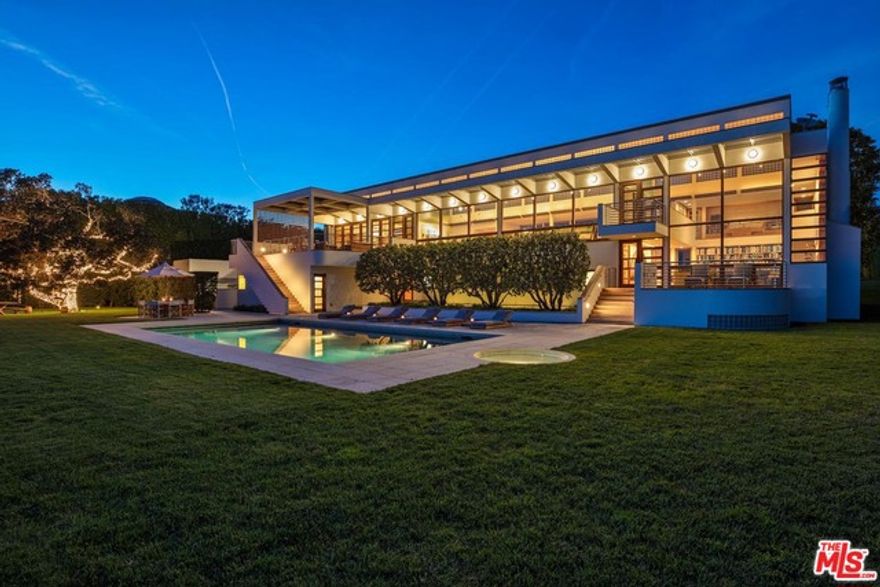One of the greatest oceanfront bluff estates in the World. Situated on over 3 park-like acres in the most exclusive area in Malibu with a private pathway to one of the most beautiful beaches anywhere. Featuring a stunning contemporary home with high ceilings and walls of glass, designed by Charles Gwathmey. There is a spectacular living/great room overlooking shimmering ocean views, gorgeous lawns and large swimming pool. Incredible master suite with two-story paneled library and gallery, open gourmet kitchen/family room, professional state-of-the-art theater, gym, home office, beautiful guest/family suites and much more. Additional amenities include two guest houses, a championship N/S tennis court, spa house, and total privacy and seclusion.