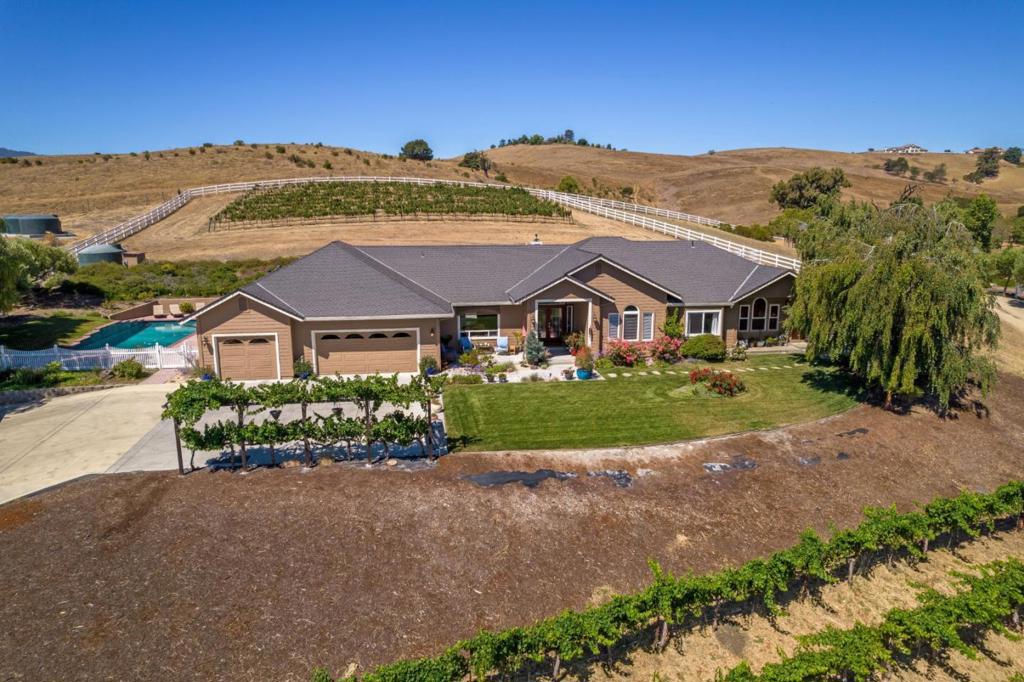 Secluded country living just minutes from downtown Hollister. Once you enter this private gated country estate and boutique winery, you will be transported to another place and time. Located on 5 fenced acres, this single story ranch house boasts 5 bedrooms & 3 1/2 baths - 3164 SF with a 499 SF attached ADU. The gourmet kitchen has a 6 burner Viking range, double oven, granite counters, center island, and breakfast bar. The backyard is it's own oasis with a covered BBQ kitchen that has a wood burning fireplace and 3 ideally centered fire pits. The yard also has a pool and hot tub. This home comes with it's own vineyards plus a fully operational boutique winery and tasting room. The winery and wine room are a short walk from the main house and have their own access driveway with ample parking for guests. A perfect opportunity for the wine enthusiast who would love to make their own wine! Beautiful southeast views of the Diablo mountains Come home to this one of a kind vineyard estate.