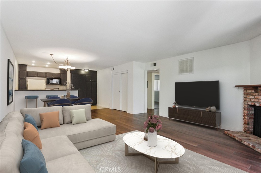 REDUCED!! Don't miss this fabulous opportunity to own a beautifully updated two-bedroom condo in the heart of Canoga Park! Priced under $400K, this front-facing unit offers style, comfort, and convenience in a quiet, tree-lined cul-de-sac location. Step inside to find glistening wood-like flooring, fresh paint, and an open-concept layout that combines the living, dining, and kitchen areas seamlessly. Enjoy the cozy fireplace in the spacious living room that opens to a private front patio—perfect for relaxing or entertaining. The updated kitchen features ample counter space and cabinetry, while the updated full bath boasts a newer vanity, quartz countertop, and sleek glass shower doors. Both bedrooms are generously sized—one with a huge walk-in closet and the other with sliding door access to a serene balcony with treetop views.This unit includes in-unit laundry (washer and dryer included) and has two gated, side-by-side parking spaces—not tandem! Located in a well-kept, smaller complex with low HOA dues of just $300/month. Minutes from Warner Center, the Rams practice facility, Westfield Mall, The Village, Costco, and the Orange Line. What more can you ask for great location, low Hoa dues and a sharp looking home. This one won’t last long!