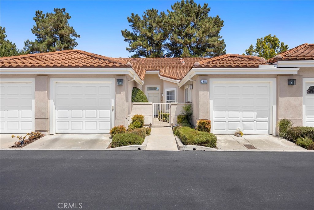 Welcome home. In the heart of the privately gated 55+ community of Palmia. Located near the end of a cul de sac. Enter the privately gated courtyard between your two garages. This spacious open concept floorplan has approximately 1278 sqft of living space with 9 ft. ceilings and extensive use of windows for lots of natural light. Large eat-in family room with neutral carpet, media niche and cozy fireplace. Large kitchen with breakfast nook, large counter, cabinet space and ceiling fan. Large Primary suite with ceiling fan and sliding glass door. Primary bathroom with dual sinks, plenty of storage cabinets, convenient walk-in shower and walk-in closet. Spacious secondary bedroom with ceiling fan is perfect for guests or home office needs. Sliding glass doors from family room or primary bedroom leads to private back patio with patio cover, privacy wall and lush landscaping. Palmia is a 24 hour privately gate 55+ community for the active senior. Enjoy resort style community clubhouse and amenities. Pool, spa, tennis, pickle ball, 18-hole natural grass putting green, clubhouse with meeting rooms and community activities. Lake Mission Viejo access. HOA fees include cable and internet services.