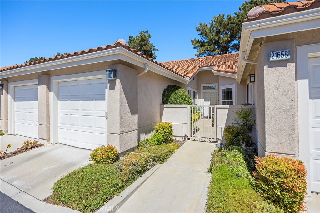 Welcome home. In the heart of the privately gated 55+ community of Palmia. Located near the end of a cul de sac. Enter the privately gated courtyard between your two garages. This spacious open concept floorplan has approximately 1278 sqft of living space with 9 ft. ceilings and extensive use of windows for lots of natural light. Large eat-in family room with neutral carpet, media niche and cozy fireplace. Large kitchen with breakfast nook, large counter, cabinet space and ceiling fan. Large Primary suite with ceiling fan and sliding glass door. Primary bathroom with dual sinks, plenty of storage cabinets, convenient walk-in shower and walk-in closet. Spacious secondary bedroom with ceiling fan is perfect for guests or home office needs. Sliding glass doors from family room or primary bedroom leads to private back patio with patio cover, privacy wall and lush landscaping. Palmia is a 24 hour privately gate 55+ community for the active senior. Enjoy resort style community clubhouse and amenities. Pool, spa, tennis, pickle ball, 18-hole natural grass putting green, clubhouse with meeting rooms and community activities. Lake Mission Viejo access. HOA fees include cable and internet services.