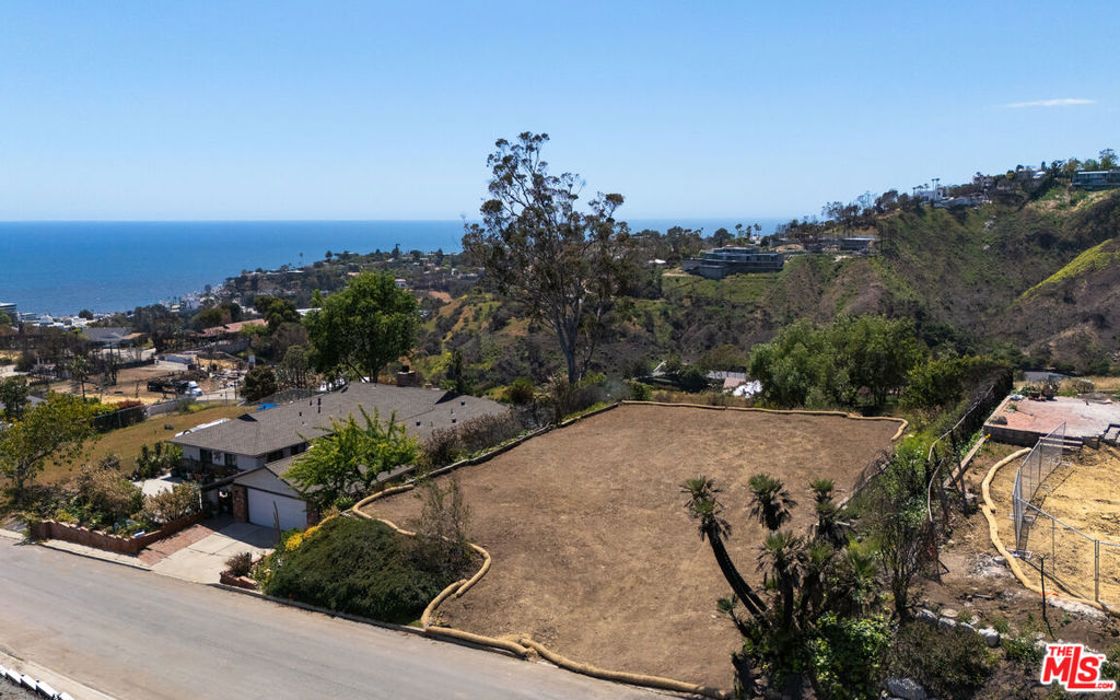An exceptional RTI (Ready-to-Issue) development opportunity with sweeping, unobstructed ocean views on a generous 11,197 sq ft lot in the heart of Pacific Palisades. Perched to capture dramatic vistas from Catalina Island to Topanga Point, this rare offering allows a buyer or developer to break ground immediately, eliminating the long wait typically associated with permitting and design.The existing RTI plans present a thoughtfully designed layout, but they may be modified to suit the buyer's needs offering the flexibility to add bedrooms, bathrooms, or reconfigure interior spaces. There is ample room for a pool, and the expansive basement level provides additional space for a gym, theater, wine cellar, office, or guest quarters. Located just minutes from Palisades Village, this parcel offers both seclusion and convenience close to top-rated schools, high-end shops, acclaimed restaurants, and scenic hiking trails. This is a rare opportunity to build a custom home in one of Los Angeles' most prestigious neighborhoods, with the hard work already done.Don't miss the chance to create a legacy property with commanding ocean views and unrivaled potential. Inquire for further details and next steps. The seller does not require the buyer to purchase the property with plans; such inclusion is offered solely at the buyer's discretion and is not a condition of the sale.