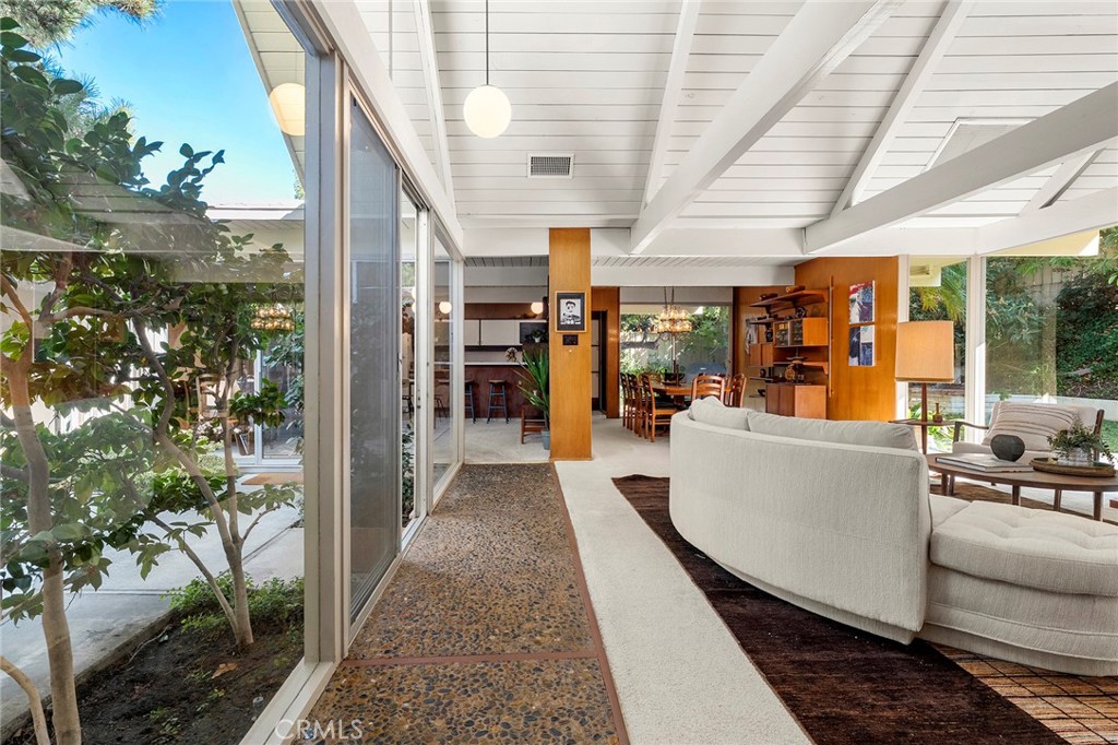 THE TOY RESIDENCE | A Jones & Emmons Masterwork
Fairhills, Orange | 1964 | The Largest Model in the Neighborhood
In the last five years, exactly three authentically original Eichlers have surfaced in Orange County. This is one of them. Houses like this don't circulate—they hibernate with families who understand what they have. The Toy family did. For 36 years, they lived here. For nearly a century each, they thrived here. You can feel that devotion in every Philippine mahogany panel.
THE BONES
The largest Jones & Emmons model in Fairhills—built in Orange's only Eichler neighborhood with underground powerlines. Architecturally intact in ways that make preservationists weep.
The Greatest Hits:
Aggregate walkway • Philippine mahogany walls • Signature atrium • Walls of glass • High tongue-and-groove ceilings + post-and-beam • Skylights • Original kitchen & bathroom vanities • Split-wing floor plan with pool access
THE PRAGMATICS
This house is solid. Recent systems: Foam roof (coated) • Hot & cold water repipe • Sewer line sleeved • Two HVAC units (brand new + 2-year-old) • Upgraded electrical • Pool ready for your vision
You're not inheriting deferred maintenance. Big-ticket items are handled. Your budget goes toward—the fun stuff that makes it yours.
THE FAIRHILLS DIFFERENCE
Mature trees. Quiet streets. The kind of neighborhood where people wave at dusk.
THE LIFESTYLE
Living in a glass-box home alters your relationship with time, light, and seasons. You'll watch storms from your atrium. You'll understand why post-and-beam isn't just structure—it's rhythm.
This is for people who understand that original Philippine mahogany isn't just wood—it's a conversation with 1964. Who know authenticity isn't a trend; it's a discipline.
Live where you Love. Love where you Live.
The Toy Residence isn't asking you to fix it. It's asking you to continue it. You deserve a house that's already solid. Already sacred. Already yours—you just don't have the keys yet.