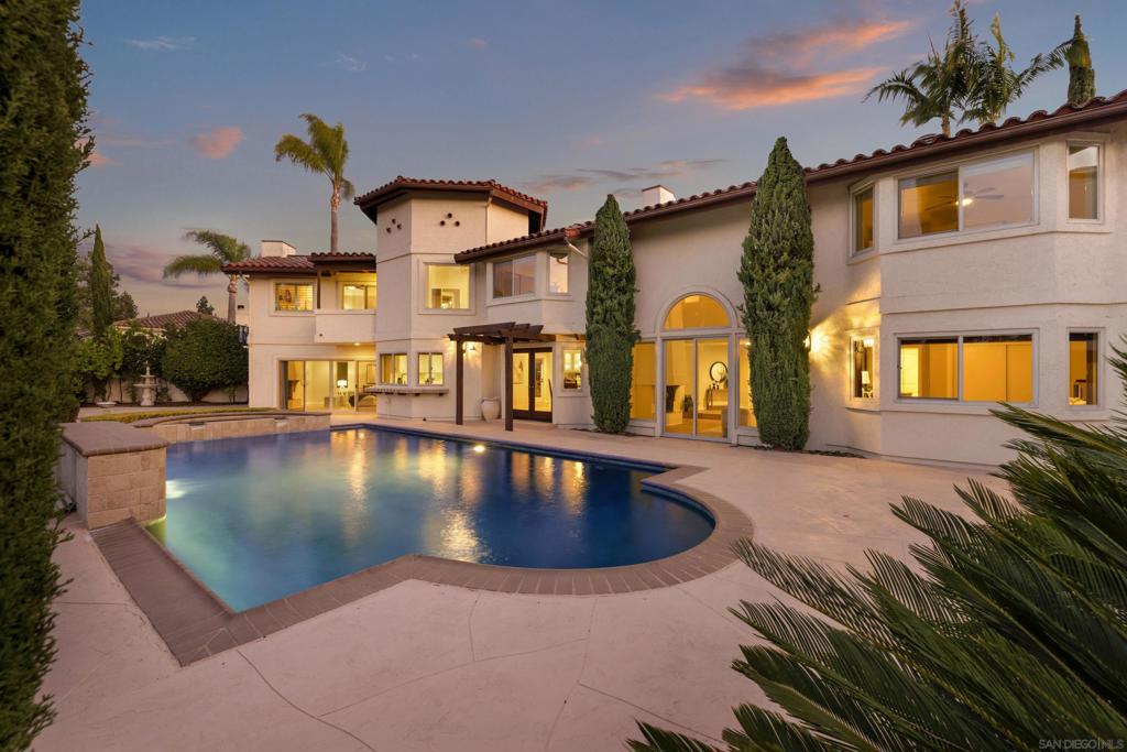 Welcome to your dream home in the prestigious gated community of Fairway Pointe, where luxury and lifestyle converge. This stunning 4-bedroom, 4-bathroom residence spans 4,680 sqft on a 9,559 sqft lot in a quiet cul-de-sac with breathtaking views of the golf course, city lights, and surrounding mountains. The bright, open floor plan features soaring ceilings, a spacious entertainment loft, and three fireplaces located in the living room, family room, and master suite. A full bedroom and bathroom downstairs make it ideal for multi-generational living, while the gourmet kitchen boasts stainless steel appliances, double ovens, granite countertops, and crisp white cabinetry. The expansive master suite offers a private balcony and spa-like bath with panoramic views. Step outside to your own tropical oasis with a sparkling pool, jacuzzi, and lush landscaping filled with palms, Italian cypresses, and fruit trees. Enjoy access to the exclusive Bernardo Heights Club—complete with pools, gym, tennis and basketball courts, playground, and more—all included in the HOA. Located in the award-winning Poway Unified School District and just minutes from parks, shopping, dining, freeways, and beaches, this home is more than a residence—it’s a lifestyle.