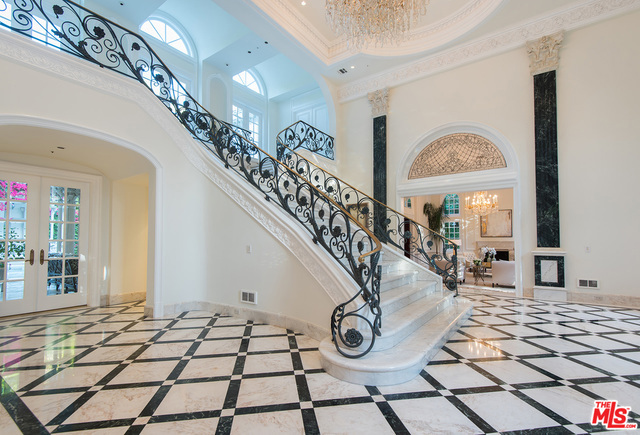 Impressive European estate in prime Beverly Hills. The dramatic 2-story entry is surrounded by grand public spaces with great attention to detail throughout. Elegant formal dining, family and living rooms with soaring ceilings, elaborate fireplaces and French parquet floors. The large gourmet kitchen leads to office and maids rooms. Upstairs are 4 bedroom suites including luxurious master with fireplace and outdoor terrace overlooking tree top views. Lower level features a media room with wood coffered ceiling, wine cellar, staff quarters, gym and 4 car garage. The lush grounds are ideal for entertaining with swimmer's pool, spa and gazebo. This hard to find estate is available today. Spectacular!