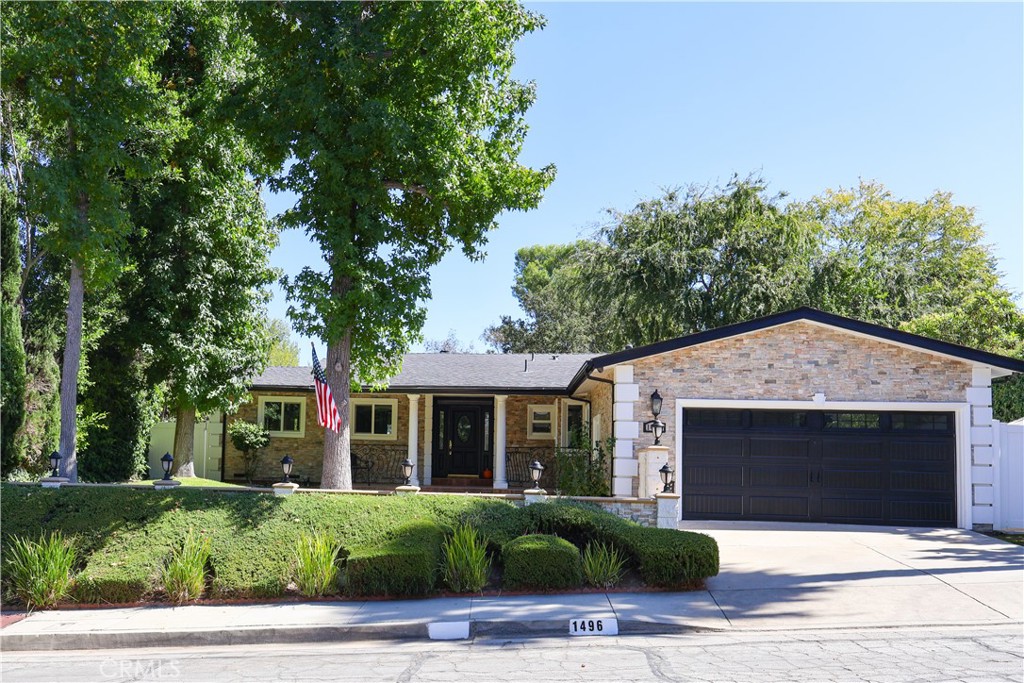 Nestled in the serene hills above the prestigious Chevy Chase Country Club and its historic 9 hole golf course designed by William P. Bell, this updated 3 bedroom, 2.5 bath single family gem at 1496 Belleau Road, Glendale, CA 91206, spans 1,968 square feet on a generous 0.34 acre lot, offering the perfect blend of privacy, lush surroundings, and modern comfort. Built in 1956 and thoughtfully refreshed, the home welcomes you with an open floor plan that flows effortlessly from an inviting living room boasting a cozy fireplace and vaulted ceilings to a formal dining area ideal for gatherings. The chef's kitchen shines with granite counters, stainless steel appliances, a breakfast nook, and ample space for culinary creativity. Retreat to the spacious master suite, featuring a luxurious remodeled bathroom with a jetted soaking tub, separate shower, and elegant stone and wood finishes. Two additional well appointed bedrooms and a full bath provide ample space for family or guests. Step outside to your private backyard oasis, complete with a large deck overlooking expansive canyon views, a side yard for play, and plenty of room to entertain or unwind in tranquility. Additional highlights include central air conditioning, crown molding, recessed lighting, and a 2 car attached garage with bonus half bath. Situated in the desirable Chevy Chase neighborhood, this home combines timeless charm with contemporary upgrades, making it a rare opportunity for discerning buyers seeking hillside elegance just minutes from Glendale's vibrant amenities.