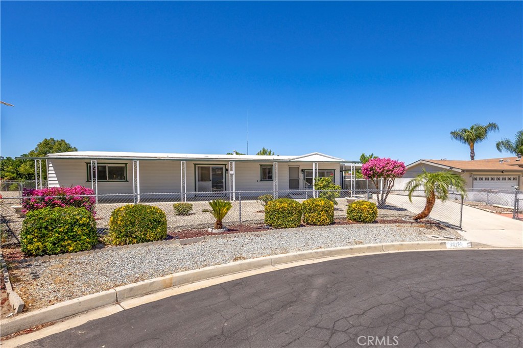 Welcome to Bautista Estates, a 55+ Community in East Hemet!
Enjoy low HOA fees and a beautifully updated 1,440 sq ft manufactured home nestled at the end of a quiet cul-de-sac.
Step into a bright formal living and dining area filled with natural light from large windows. The open-concept kitchen and family room offer the perfect space for everyday living and entertaining. The kitchen features newly painted cabinets, modern appliances, and an island with a built-in cooktop. The family room includes a custom bar and opens to a covered front patio—ideal for gatherings with family and friends.
The spacious primary bedroom boasts fresh paint and new flooring, while the en-suite bathroom includes a walk-in shower, updated vanity, and sink. The guest bedroom is private and roomy, complete with mirrored wardrobe doors and easy access to a full guest bath with a tub/shower combo.
Additional features include an inside laundry/utility room, a large Arizona room, a detached shop, and a covered carport. The entire property is fenced and landscaped for low maintenance, offering comfort and privacy. Upgrades include newer laminate flooring, interior paint, and ceiling fans throughout.
Don’t miss this great opportunity—schedule your tour today!