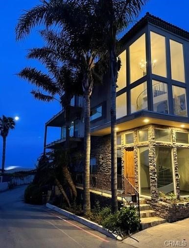 This fully furnished 3-story beach home is situated on a bluff overlooking the South Laguna Beach coastline. It is tucked away at the end of the cul de sac in the Secret Cove community, which has limited guarded access during the summer months. On the south side of Pacific Coast Highway it is a short, scenic walk to the sand by way of a private beach access staircase, the trolley stop, and local eateries. The interior of the home has been renovated, taking its inspiration directly from the coastline that lines the panoramic windows, which provide 180 degrees of nearly unobstructed views.
The entry level features a studio apartment with it's own entrance off of the patio. It has a kitchenette, bathroom, and access to the spa. The main level is just off the floating spiral staircase and was thoughtfully designed to maximize views whether you are enjoying a meal at the large live edge table, playing chess at the seating area, or preparing the catch of the day in the completely renovated kitchen. Also on the main floor are two bedrooms with a Jack-and-Jill bathroom, a powder room, and wet bar. The third floor features a sitting area with pull out sofa just off of the master bedroom and bathroom. The views can be enjoyed from the moment you wake up to the moment you unwind in the large oval tub.
The glass enclosed balconies wrap around both the second and third floors where you can catch some of the most spectacular sunsets, boats, paragliders, and whales and dolphins that are known to frequent this cove. The sound of the crashing waves and seagulls never disappoint! Just beyond the views of the white sands and crashing waves on Laguna's famed rocks, Catalina Island is in clear view. Parking will never be an issue with 2 garage parking space and 4 driveway parking spaces, an unheard of amount of parking in the beach communities. Brand new washer and dryer are included as well as central a/c.
The residents that are lucky enough to call this spectacular house "home", whether for a month or a year, have the rare luxury of being tucked away in a seclude community while simultaneously being in the center of it all minutes away from Five Star Resorts, Golf, Tennis, Main Beach, Dana Point Harbor and more.
Pets are welcomed, side yard is fenced.
Minimum term 30 days.