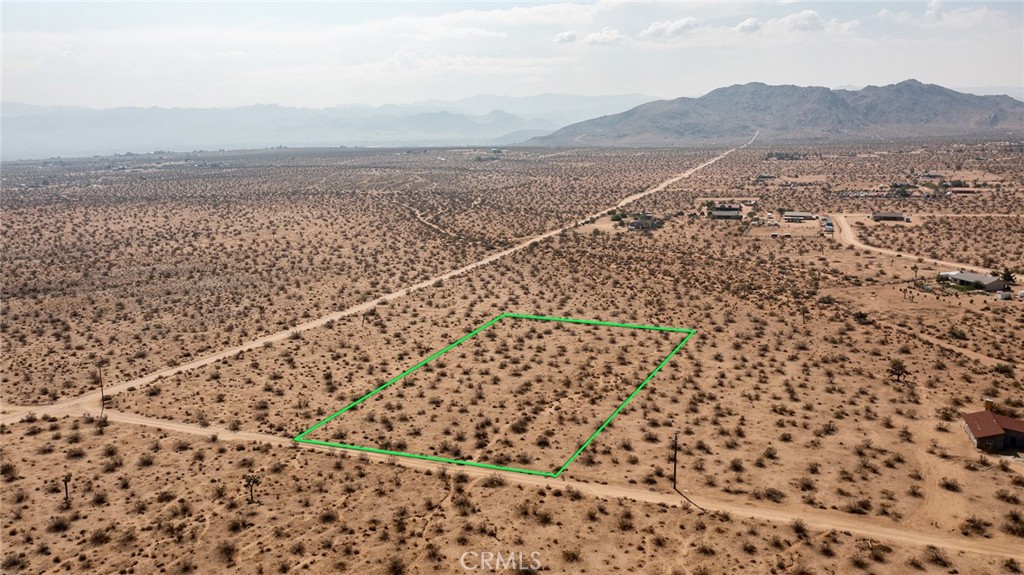 2.32-Acre Lot located in up-and-coming area of North Joshua Tree. Water & Electricity (utilities) nearby. Several new homes in the area. Great views from this elevated location. Rural. Surrounded by vast wilderness. Mountains nearby. Hiking. Fantastic sunrises to the east. NOTE: Green lines demarcating boundaries in pictures are approximate, as property has not been surveyed; street address is not official – do not use address or google map GPS to locate property. To find property, please locate with APN: 0599-501-08