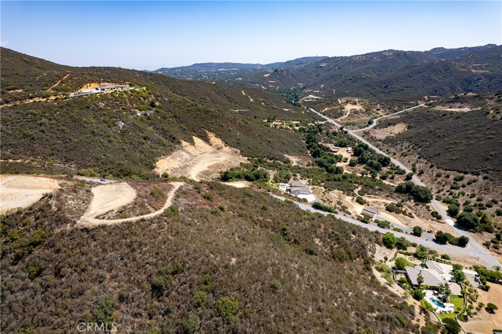RARE LA CRESTA ESTATE PARCEL, VIEWS, USABLE LAND & UTILITIES AT THE STREET! KING OF THE HILL ! Perched in one of La Cresta’s most sought-after view corridors, this 6+ acre parcel offers the perfect blend of stunning vistas, usable terrain, and a prime location close to town. From the moment you arrive, you’ll feel the sense of possibility this isn’t just another lot, it’s the foundation for your dream estate. Located just 6 miles from Clinton Keith Road, you’ll have quick access to shops, dining, schools, and daily conveniences, while still enjoying the peace and privacy that make La Cresta so special. Set off a lightly traveled road the property strikes the ideal balance between seclusion and accessibility. A gently graded driveway leads you to the crown of the land, where the views are breathtaking. Sunrises and sunsets here are nothing short of spectacular. The parcel’s gentle topography offers generous usable space perfect for a main residence, pool. For horse enthusiasts, the property’s layout and location are ideal, with La Cresta’s extensive private trail system nearby. Gentle breezes from Camp Pendleton keep the air fresh year-round, adding to the comfort of this peaceful setting. If agriculture is your passion, the area’s climate and soil support everything from vineyards to olive groves to organic gardens. Unlike many rural parcels, this one is ready to build with water and power available at the street keeping development costs down and making your dream home a reality sooner. La Cresta’s appeal extends far beyond its beautiful land. With 5-acre minimum parcels, the community offers a rare sense of space and privacy. There are no commercial businesses here just rolling hills, luxury estates, equestrian facilities, and thousands of acres of preserved land. Social gatherings, community events, and miles of trails make it easy to connect with neighbors, while the nearby Santa Rosa Plateau Ecological Reserve offers endless outdoor adventure. Despite its country charm, La Cresta is remarkably accessible just minutes from the 15 Freeway and within 1 to 1.5 hours of San Diego, Orange County, Los Angeles, Palm Springs, and Big Bear. This is more than a lot it’s an opportunity. Build your dream estate, or invest in one of the last premium parcels in this coveted area. Walk the land, take in the views, and picture your future here. Opportunities like this are rare, and once it’s gone, it’s gone. Schedule your private tour today.
