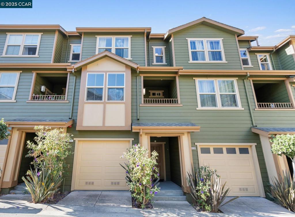 Welcome to 6071 Old Quarry Loop, a beautiful home in the desirable Monte Vista Villas community, set in the Oakland Hills. This 3-bedroom, 3-bathroom residence offers 1,752 sq ft of well-designed living space with vaulted ceilings and hardwood floors. The open layout features a bright living and dining area with large windows that bring in abundant natural light. With three levels, each bedroom provides privacy and comfort. The upper-level primary suite includes a luxurious en-suite bathroom with peek-a-boo views of the San Francisco Bay. On the main level, a bedroom with a private balcony offers a peaceful retreat. The lower level includes a third bedroom with an en-suite, a laundry room, and direct access to a spacious 2-car tandem garage with extra storage. Thoughtfully updated with beautiful hardwood floors—just unpack your bags and move right in, no work needed! Monte Vista Villas amenities include a clubhouse, gym, playground, and nearby hiking trails. Conveniently located near the 580 freeway, regional parks, Oakland Zoo, and Chabot Space and Science Center, this home offers easy access to both work and play. Complex is VA Approved – FHA may be possible – don’t miss this!
