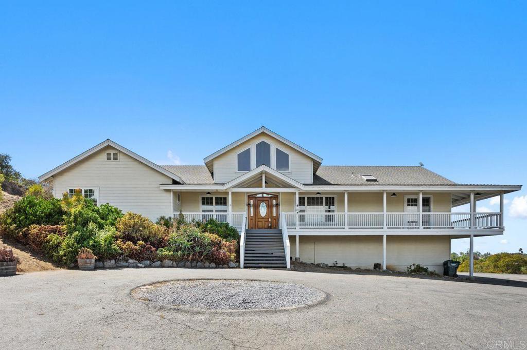 Gorgeous ocean view home in the country. Steps to front door of one story house with large wrap around porch, just bring your rocking chair. Built in 2003, this 3314 Sq Ft home sits on 1.62 acres with 4 bedrooms, 3 baths. Great home & property but needs some TLC to make it your own. Interior is all on one level with a very open flowing floorplan & 26' soaring ceilings in Family room. Includes formal living room, family room with fireplace, dining room with unbelievable views & kitchen with granite counters, stainless appliances, breakfast bar & nook, butcher block center island & built-in desk. Master suite with great view, has large walk-in closet, bath with jetted tub, oversized shower with dual shower heads, sky lite, His & Hers sinks & walk-in closet. Large laundry room with a wall of cabinets, lots of counter space, laundry sink & outside access to large brick patio. Two bedrooms have pull down stairs to attic areas 7'x40'. Large flat yard to huge garden area to grow your own vegies. Fruit trees, 2 chicken coups & 20 x 20 metal barn. Located in the county area of Vista, so you can bring horses or animals. Two central heating & A/C units. 30 panel solar system all paid for. Huge five car tandem garage with tons of storage & dumb waiter lift to main floor, work bench with 220 plugs. Lots of parking for RV's & trucks.