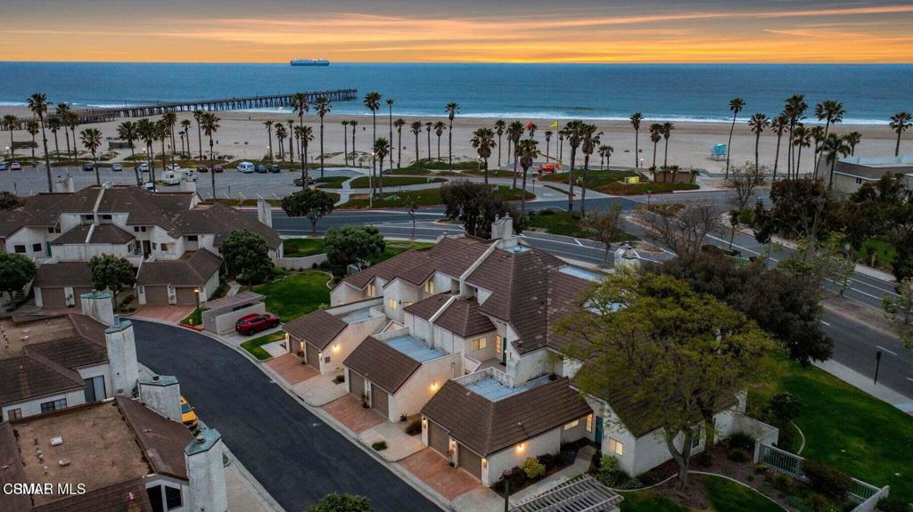 Live by the beach; this beautiful three-bedroom, two-bath townhome features an open floor plan, gorgeous flooring, new kitchen cabinets, stainless appliances, beautifully updated bathrooms, a formal dining area, a beautiful living room with high ceilings, and a fireplace. There are two ocean-view balconies, one with access from the living room and downstairs bedroom. The upstairs master bedroom also features beautiful large balcony with ocean views, dual closets, a remodeled bathroom with dual sinks, updated fixtures, and a large, custom shower. Also with indoor laundry. Enjoy stunning sunset views and a walk on the beach. This beautiful townhome features a garage, and it is in a gated community. Community amenities include Pickleball, tennis, and basketball courts, a kids' play area, an indoor pool, a spa, a sauna, clubhouse & gym.