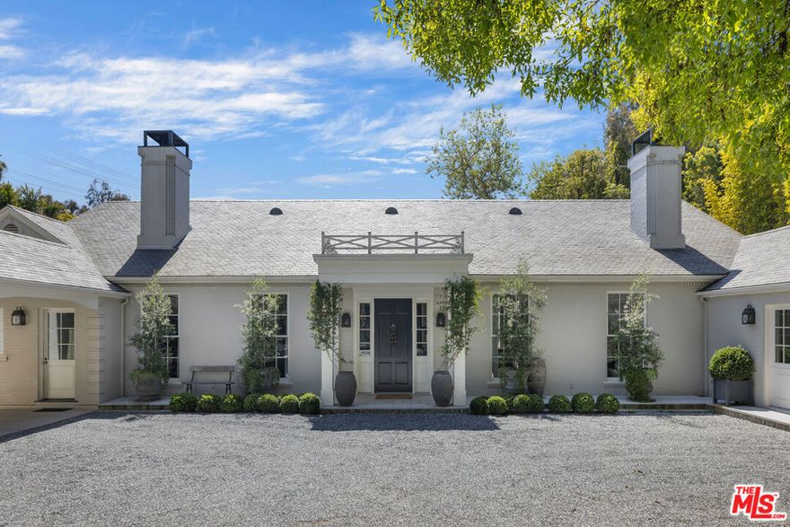 Discover timeless elegance and modern sophistication in this Southern Transitional estate, designed by Windsor Smith. Set on nearly 30,000 square feet of flat, lush grounds, this private sanctuary is hidden behind tall hedges, offering unparalleled privacy and tranquility. As you step inside, reclaimed wood floors and intricate patterned stonework create an immediate sense of warmth and charm. The open, airy living spaces are bathed in natural light, with high ceilings, elegant moldings, and French doors leading to a beautifully landscaped backyard perfect for entertaining or family gatherings. At the heart of the home is a chef's dream kitchen, fully outfitted with double cooktops, double ranges, and a wood-burning oven. A generous center island and cozy breakfast nook overlook the verdant yard, while the adjacent family room, lined with floor-to-ceiling bookshelves, provides a peaceful retreat. The romantic primary suite offers a luxurious escape, complete with his-and-hers bathrooms for ultimate privacy. Thoughtfully designed secondary bedrooms feature charming built-in bunk beds and dormer windows, adding both function and whimsy. Meticulous craftsmanship is evident throughout the home, from the soaring ceilings and custom cabinetry to the exceptional millwork. Outside, the mature landscaping and expansive grounds offer endless possibilities for outdoor activities, gardening, or simply relaxing by the luxurious plunge pool. For the ultimate in entertaining, the newly built guest house features stackable pocket doors for seamless indoor-outdoor flow, a grand entertainment area, a fully equipped gym, a state-of-the-art movie theater, and a temperature-controlled wine cellar. A separate large guest suite and a sunny apartment above the garage provide perfect accommodations for guests or staff. Ensuring the utmost convenience, the home is equipped with advanced water filtration systems, including sediment and carbon block filters, ultra-pure alkaline drinking water systems, and more guaranteeing the highest quality water throughout. This exceptional Brentwood estate offers a rare blend of luxury, privacy, and modern living. Don't miss the opportunity to make this remarkable property your own.
