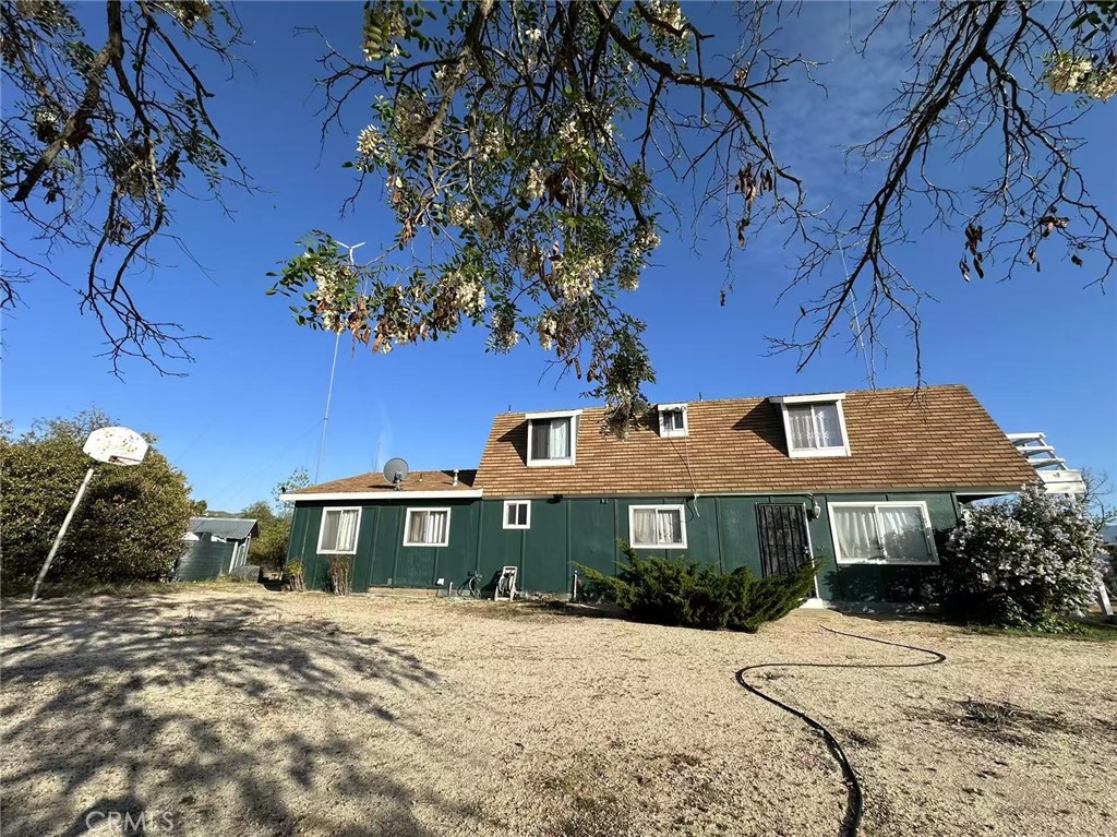 Nice country barn house. It has 3 bedrooms upstairs with a full bathroom. The kitchen, dining area, and living area has a beautiful floating hardwood oak floor in fantastic condition. The downstairs bathroom is built handicap accessible and one of the offices is located right across the hall. The living area has a wood stove and there is an enclosed porch that is entered from the living room but also has entry from the outside. This home has a good roof. The property has a workshop and 2 different storage containers. newly upgrade 200AMP Panel. This home has a lot of potential. Must see to appreciate! Only 45 minutes to Palm Desert or Temecula, 30 minutes to Idyllwild.