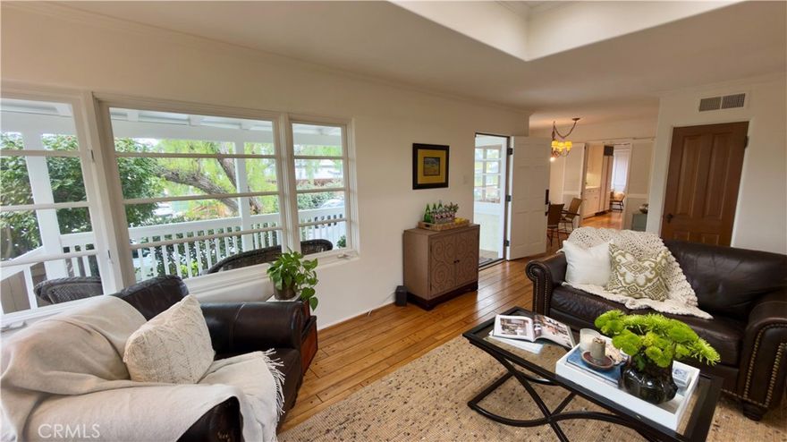 Ideally located in one of the most desirable neighborhoods at the heart of the Laguna Beach Village, this charming oversized cottage offers panoramic ocean and Catalina views on an extremely private lot. From the moment you walk in the front door, you will be immersed into the natural light-filled living room that showcases a large skylight and gas fireplace. The pristine 4 bedroom, 3 bath features a primary bedroom suite, as well as two other secondary bedrooms and bathroom, on the main level.  Upstairs there is a large flex room that can be used as a primary bedroom, den, or game room that boasts brand new French doors with incredible Pacific Ocean / Catalina views.  Wood floors enhance the entire home, while the updated galley kitchen, laundry closet and dedicated work space make first floor living easy.  The attached 2-car garage is complete with built-in storage and tall ceilings. There are 2 additional spots for parking in the driveway. The home is bordered by a view porch in the front to enjoy the ocean breezes and a smaller, discreet porch located in the back off one of the secondary main floor bedrooms. The beautiful, mature landscaping accentuates the cozy and private elements of this property and generous side yard while amplifying the seamless indoor / outdoor lifestyle Southern California is known for.  Its close proximity to beaches, downtown dining and shopping are some of the true benefits of living in The Laguna Village.  Don’t miss the opportunity to make 508 Seaview your private treasure.