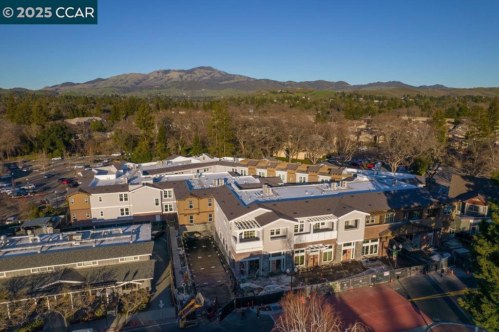 600 Hartz, where classic beauty & modern elegance coalesce, nestled in the heart of downtown Danville. This new boutique building boasts a collection of 36 luxury residences in sixteen different floor plans with 1, 2, or 3 bedrooms, each designed around a lushly landscaped courtyard, offering a tranquil escape for residents. Given its prominent location, the architectural design of 600 Hartz was crafted to complement the historic charm and character of Danville. (visit the website @ 600Hartz.com). Nestled in a prime location, this stunning single level townhouse style residence offers a seamless blend of comfort and style. Step inside to discover a beautifully appointed kitchen featuring sleek quartz countertops, rich dark wood cabinetry, and premium stainless-steel appliances—an inviting space for both casual meals and gourmet creations. The open floor plan extends effortlessly to a charming front patio, perfect for morning coffee or evening relaxation. Breathtaking panoramic views of Las Trampas and Mount Diablo create an unforgettable backdrop for entertaining or unwinding under the stars. Photos are of our model home #107.