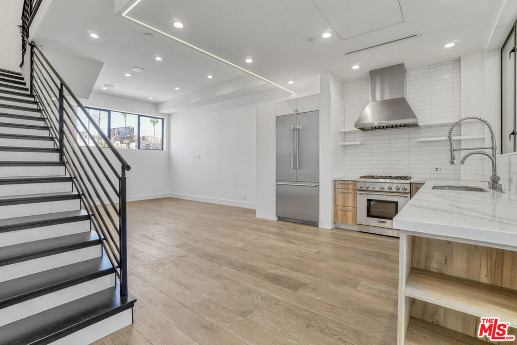 Brand-new (2021) tri-level townhome on the West Hollywood border delivers approx. 1,568 SF of open-concept living plus a private 350 SF roof deck with panoramic city-light views. Three bedrooms and 2.5 baths are grouped on a single level for easy living, while the main floor showcases premium finishes and abundant natural light. Enjoy a direct-entry two-car garage, no shared walls, turnkey condition, and walkability to Sunset Blvd hot spots, Runyon Canyon, and Beverly Hills shopping. A rare lease opportunity in one of L.A.'s most coveted sub-markets available immediately.