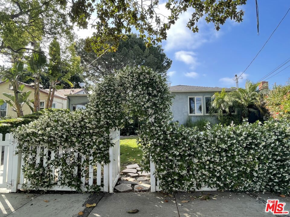 Through the archway and past the charming white picket fence is a wonderful traditional home located on a tree lined street in one of the best Mar Vista neighborhoods. This 3 bedroom, 2 bath home, has pretty hardwood floors, living room with dining area and a main suite with a walk in closet and attached bath. The galley kitchen has a stainless steel refrigerator & sink, appliances and a service porch with a stacked washer/dryer and a utility sink. Central Air Conditioning & Heat. Fenced in front & back yards, open patio and a 2-car garage. Mar Vista Elementary School District. This for a first time buyer OR a Developer/Builder, plans & permits are in place with a project ready to go! To show: call or text the listing agent. Additional photos will be posted at end of the week.