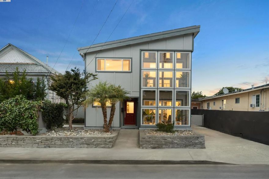 Years ahead of its time, this custom smart home was eco-friendly before green was IN! With a distinctive facade & dramatic metal skillion roof, this permitted whole home reconstruction features newer industrial decor finishes, steel I-beam & concrete slab engineering, dual zone hydronic radiant heat system & a south-facing solar atrium for passive heating. Hard-ethernet wired enabled for computerized network automation! Anchored by new LVT flooring, the main level urban/loft aesthetic is evident in an expansive kitchen with the cobalt blue cabinets & stainless steel appliances. The indoor mech room houses an eco-conscious boiler system, washer & dryer. The upper level is a 2-bed, 1-bath sanctuary perched aloft a vast open atrium. Sited on a deep lot w/generous rear setback, the freshly re-roofed oversized garage/workshop is a haven of possibilities for the car, shop, rec or small business enthusiast. Develop the property & envision live/work living or an ADU (buyer to verify). Zero pest, low maintenance grounds, walnut & avocado trees, long driveway w/plentiful off-street parking & generous side yard for a possible dog/pet run keep stress to a minimum! Central access to BART, downtown, Marina Square, freeways, airport & bridges!