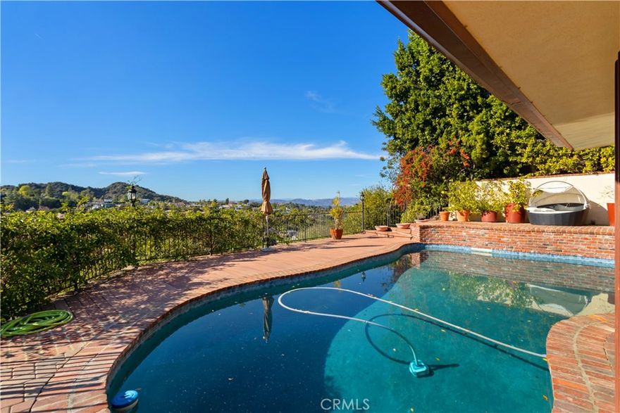 VIEWS, VIEWS, VIEWS... Very charming private 4+5 single story pool home with panoramic mountain & city light views in top rated Lanai school district. Updated chef's kitchen with large L shape granite top center Island, double Viking oven, 6 burner Viking cooktop and sitting area with mountain views. Wood floor and rec3ssed lighting throughout. 3 bedrooms on one side and one bedroom on the other side perfect for guests or in-laws. Master suite with 180-degree views and ample closet space opening to backyard overlooking the mountain and city light views. Master bathroom with spa tub, double sink, and gym. Attached two car garage. Backyard with newly updated pool, spa & mountain views. two separate viewing deck perfect for afternoon coffee or wine while enjoying the serenity and the views. Washer dryer included. Minutes from Mulholland and some of the best rated private schools. Easy access to Westside. Do not miss this beautiful view home in Encino Hills