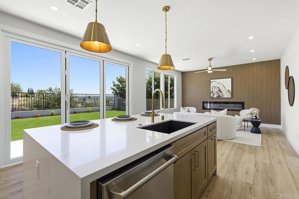 Here is your opportunity to own an impeccably remodeled 4-bedroom, 3-bathroom home offering approximately 2,200 square feet of luxurious living space, perched on a premium lot with beautiful panoramic canyon views. Every inch of this home has been thoughtfully upgraded with high-end designer finishes, making it look and feel like a model home. Step inside to find vaulted ceilings throughout, creating an open, airy ambiance and enhancing the home’s modern elegance. The spacious open-concept floor plan features custom LVP flooring, designer lighting, and cantina style folding door that flood the interior with natural light and capture the serene vistas beyond. The gourmet kitchen is a chef’s dream, complete with white oak cabinetry, quartz countertops with water fall edges, stylish backsplash, and high-end SS appliances. The adjoining living and dining areas are perfect for entertaining or relaxing while enjoying the view. Retreat to the luxurious primary suite with spa-inspired en-suite bathroom, dual vanities, an enormous walk-in shower/tub, and dual walk-in closets. There is one full bed and bath on the main level with generous space, perfect for family, guests, or a home office. There is even a 3 car garage for your toys or extra storage space! Pacific Ridge is a quiet family neighborhood surrounded by the Los Penasquitos Canyon Preserve with one of the best locations in all of San Diego. Located in the heart of the tech hub, just minutes from UCSD, Torrey Pines Beach, top-rated schools, 5/805 freeway, UTC shopping mall, endless dining options, and so much more. Whether you're hosting guests or enjoying a quiet evening on the patio overlooking the canyon, this home offers unmatched comfort, style, and tranquility. Don’t miss this rare opportunity to own this very special home.