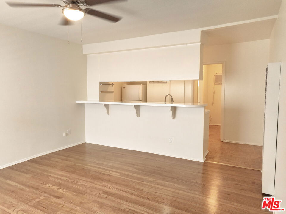 Bright and spacious top floor Studio home with parking, AC and heat, lots of natural sunlight, and original details. Prime Silver Lake location just a few blocks to all the trendiest restaurants and coffee shops, clothing stores, and high-end grocers on Sunset Blvd/Sunset Junction Area. Living spaces feature an open floorplan with large windows, a modern ceiling light/fan, and hardwood flooring. The kitchen features a breakfast bar, original white tile counters and backsplash, white wood cabinetry, modern hardware, a fridge, stove/oven, and plenty of room for storage. Extra storage space in the hallway along with a wall AC unit. The bathroom features a modern wood vanity with quartz countertops and backsplash, and a spacious shower stall with new shower door and white tile shower walls. Unit comes with 1 parking space. Shared laundry in building. Short drive to Echo Park, Los Feliz, DTLA, and Hollywood. Enjoy a luxury living experience in Prime Silver Lake.