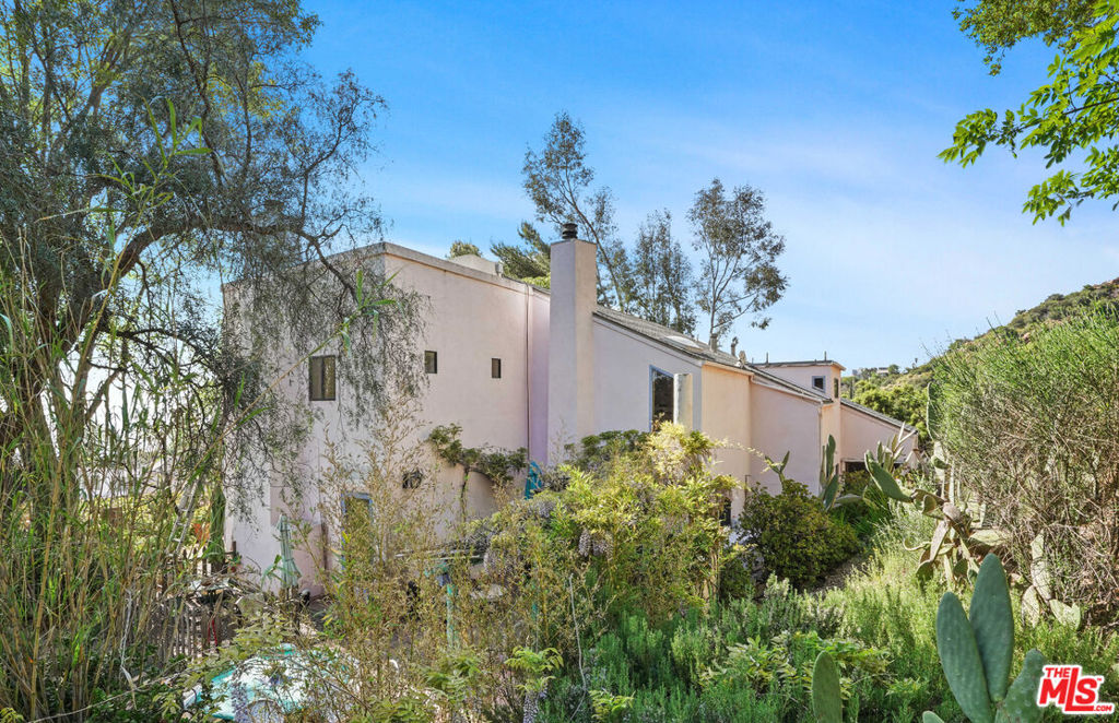 Presenting the ocean view, private, gated compound of renowned Sculptor and Printmaker Eugene Sturman. First time on the market in almost 50 years. #Vintage70's! Located within a coveted gated neighborhood, this property features magnificent ocean views and magical sunsets overlooking Pt. Dume. Calling all Artists, Musicians, Writers, Filmmakers, Creative Visionaries & Car Collectors, to re-imagine this Diamond in the Rough with 3 separate structures. Live in one, rent out the other, and work in a huge, light filled 2-story art studio with high ceilings and concrete floors. Situated on 2.03 acres behind the gates of W. Saddle Peak Rd., the drought-tolerant landscape features succulents, cacti, pepper trees, eucalyptus, ash, oleander, live oaks, manzanita, acacia, toyon stone pines and ceanothus trees, yellow blooming desert broom along with an abundance of purple blooming, pride of madeira and many other succulents, accentuating the dramatic rock formations. The property consists of 3 separate Structures: STUDIO A (closest to Loma Metisse Rd.) is used as a sculpture studio and is open for interpretation and your imagination. Comprised of a "footprint" of approximately 1,450 sq. Ft., there are two floors. Main floor has an approx. 400 sq. ft. office / drawing room with an approx. 1,000 sq. ft. Studio with natural light. About 1,000 of "crawl space", 6-8' in height, currently used as storage and undeveloped, is beneath. Underneath the office / drawing room, is an approx. 400 sq. ft. Garage with concrete floors, for 2 cars. No bathroom, but the building does have water. MAIN HOUSE: 2 Beds, 2 baths, 2 stories. Features ocean views over Pt. Dume, approximately 1,628 sq. ft., per the Tax rolls. One bed and bath downstairs, 1+1 upstairs. The main floor comprises a kitchen, dining space, family room with fireplace, a great room also with fireplace, all opening to a charming garden patio with outdoor kitchen and seating area. You could potentially add a floor above the living room area to enclose a 3rd bedroom on the second floor. STUDIO B / Guest House (building at top of property) has approx. 1,800 sq. ft., 2 story living quarters, approx. 400 sq. ft. each floor, with kitchen & laundry on main floor and 1 bed, 1 bath upstairs, plus an attached studio which adds another approx. 1,000 sq. ft. of usable space. Could house a car collection for example, or be a sound studio, etc. Built in 1979, this mesmerizing property is a cosmetic "fixer" with a TON of potential, and HUGE income possibilities. Live your Malibu dream in nature and fresh air. 15 min. to Malibu Canyon with easy access to the 101 freeway, or go down Piuma to Rambla Pacifico, to Las Flores Canyon to Malibu beaches, Pacific Coast Hwy., Schools, Shops, Farmers Market. You can also cut through to Topanga Canyon by following W. Saddle Peak to Tuna Cyn to Fernwood Pacific. Great hiking nearby. Priced to sell!