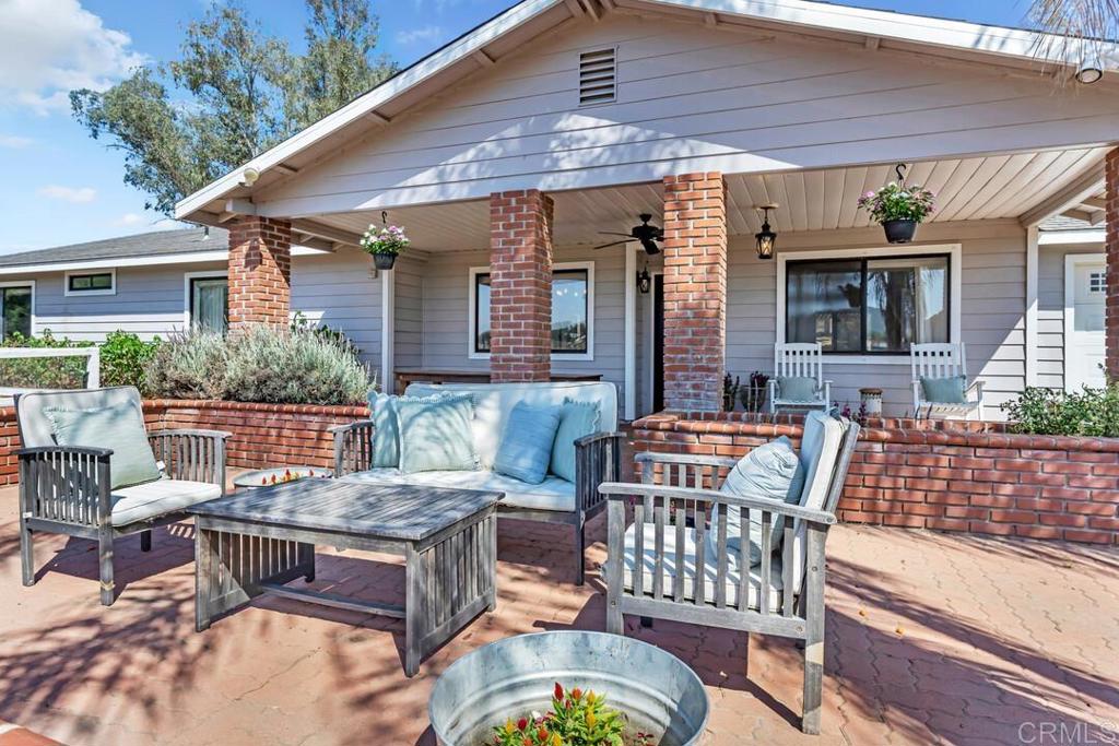5.69-acre Private Ramona Oasis | Organic, Upgraded & Ready to Thrive Welcome to your dream property in the heart of Ramona — a beautifully updated 3 bed, 2 bath, 1,752 sq ft home with open layout, modern upgrades, and endless outdoor possibilities. Set on a fully fenced and gated lot next to a protected wildlife preserve, you’ll enjoy year-round privacy and stunning views with no development to the west. Inside, laminate flooring flows throughout, with thoughtful finishes and timeless character at every turn. The open-concept kitchen features Carrera marble counters, stone tile backsplash, a farmhouse sink, large island, pot filler, and tons of storage — ideal for everyday living and entertaining. The spacious primary suite offers a walk-in closet and a beautifully remodeled en-suite bath. Outdoors, unwind by the sparkling 36,000-gallon pool (replastered in 2021, pump replaced 2023), rinse off in the outdoor shower, or fire up the built-in gas BBQ connected to house propane. Zoned A-70 and Registered Organic, the property is ready for farming, horses, and livestock. A 375-ft well with stable 11-ft water level (new motor in 2024) supplies abundant water — with city hook-ups also available. The well is generator-ready, and the home includes whole-house filtration with RO. Owned solar with 28 panels, a 4,500w backup battery (2021), and a Honda 4,500w generator offer self-sufficiency and peace of mind. Agricultural amenities include a 3-stall barn with tack room, multiple paddocks with shade, chicken coop, 3 greenhouses (1 permanent, 2 moveable), 4 large gardens, and 4 irrigated raised beds totaling 1.5 acres of growing space. Bonus outbuildings include 2 sheds, a farmstand, and a walk-in cooler. RV-friendly with 4 hook-up sites (2x 30-amp, 2x 50-amp) — one currently brings in ~$800/month via Hipcamp. Optional items include the John Deere riding mower, generator, and even the livestock and chickens. With resort-style outdoor living, sustainable systems, and space to live, grow, and earn — this Ramona property is more than a home... it’s a way of life.