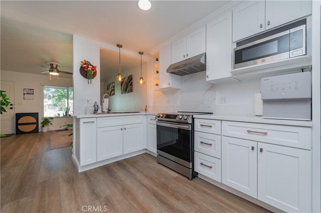 Located within the gated community of Saddleback Park Villas, this remodeled townhouse overlooks an expansive manicured lawn with no front neighbors. Zoned for Tustin Unified School District! California Distinguished School Arnold O. Beckman High School. Upon entering the home you will see upgraded luxury vinyl plank flooring through out whole house, open floor plan. Kitchen was totally renovated with beautiful quartz countertop with plenty cabinetry, dining area, making meal preparation and dining a delightful experience. New water heater, windows, lighting, recessed lights, fans, whole house new painting. Enjoy your private patio outside the kitchen area. The two bedrooms are upstairs sharing one full bathroom. The community amenities include pool, picnic area, playground, and clubhouse. Located in the heart of Orange County, this home is minutes from MainPlace Mall, Historic Downtown Santa Ana, the Discovery Cube, Santa Ana Zoo, and Tustin Market Place, just minutes from the 5 & 55 freeways, a short distance to schools, shopping and restaurants. NO MELLO-ROOS tax, and low HOA fees.