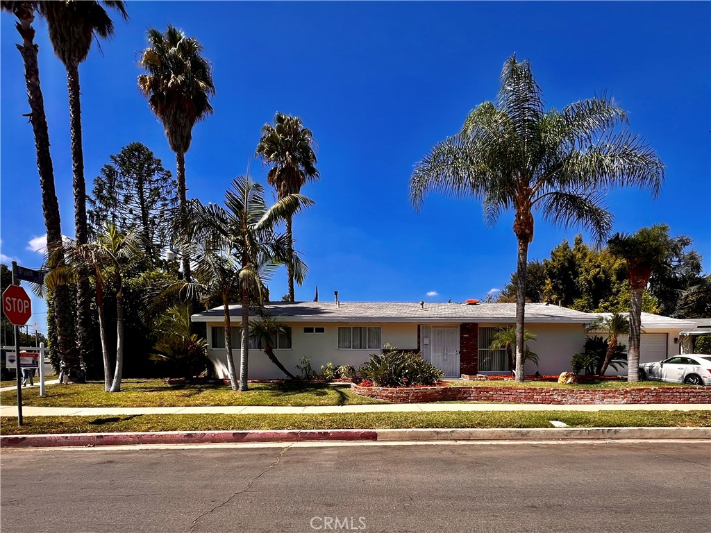 First Time on the Market in Over 25 Years! Welcome to this spacious and inviting home, located in a highly desirable neighborhood and offering nearly 1,500 square feet of comfortable living space. Featuring four bedrooms, two bathrooms, and a large enclosed patio, this residence is brimming with potential and ready to make your vision come to life. From the moment you arrive, the home’s charming curb appeal sets the tone, highlighted by a wide concrete driveway with RV access and lush mature landscaping, including several majestic palm trees. Inside, you’ll be greeted by soaring vaulted ceilings, a bright living room anchored by a cozy wood-burning fireplace, and an open dining area that flows into the kitchen with its generous pantry and breakfast nook. The central hallway features a remodeled hall bath leading to the spacious bedrooms, with two currently combined to create an oversized primary suite complete with a walk-in closet and en-suite ¾ bath. (Easily converted back to the original four-bedroom layout if desired.)The two-car garage with storage and direct access to the home adds convenience, while the expansive backyard opens the door to endless possibilities—including the potential for an ADU (buyer to verify). With some creative upgrades, this property can truly become the home of your dreams. Don’t miss the chance to make it yours!