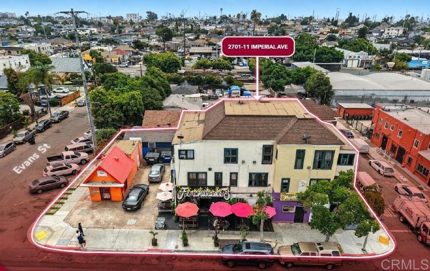 Presenting 2701–11 Imperial Avenue, a rare full-corner mixed-use asset located in the heart of Grant Hill, just two miles from Downtown San Diego. This centrally positioned 14-unit property offers a unique mix of (9) SRO-style residential units and (5) commercial storefronts, including two long-standing, 4.8-star Yelp-rated tenants: Ferchaladas and Ana’s Fruit & Deli. Set on a ±5,196 SF lot and zoned CN-1-3, the property sits within multiple development-enhancing overlays including Complete Communities Tier 3, a Transit Priority Area, and a Qualified Opportunity Zone. Under these programs, the site may allow for up to 6.5 FAR and ±46,000 buildable SF, subject to buyer verification—making it well-suited for a range of strategies including lease-up, repositioning, or full redevelopment. Whether acquired for long-term cash flow or future infill development, the property benefits from central access to Downtown, Balboa Park, Logan Heights, Golden Hill, Sherman Heights, and major freeways. Surrounding the site are numerous public and private redevelopment efforts, contributing to steady growth in one of San Diego’s most strategically located urban corridors. Buyers are advised to independently verify all development potential with the City of San Diego. Shown by appointment only — please do not disturb tenants or businesses. Reach out to listing agents for more information. Ivan Del Muro-Garcia Lic#0216936