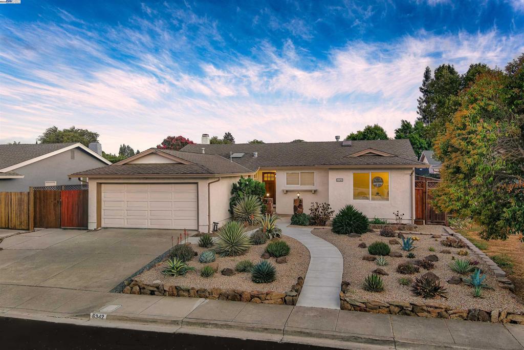 A stunning, low-maintenance landscaped front yard with a charming walking path invites you into this 4-bedroom, 2-bath, 1,603 sq. ft. Pleasanton gem. Inside, an open-concept kitchen, dining, and family room flows effortlessly—perfect for entertaining or everyday living. The chef’s kitchen shines with granite countertops, stainless steel appliances, a wine fridge, double sinks, and endless counter space, while skylights and recessed lighting fill the space with warm, natural light. Generous pantry and storage keep everything beautifully organized. Beautiful hardwood and tile floors extend throughout the home, guiding you to a private, serene backyard with a low-maintenance patio—ideal for gatherings or quiet afternoons—plus RV parking and solar panels for modern convenience. All of this just steps from downtown Pleasanton’s shops and restaurants, parks, and top-rated schools—where comfort, style, and effortless living come together in one exceptional home.