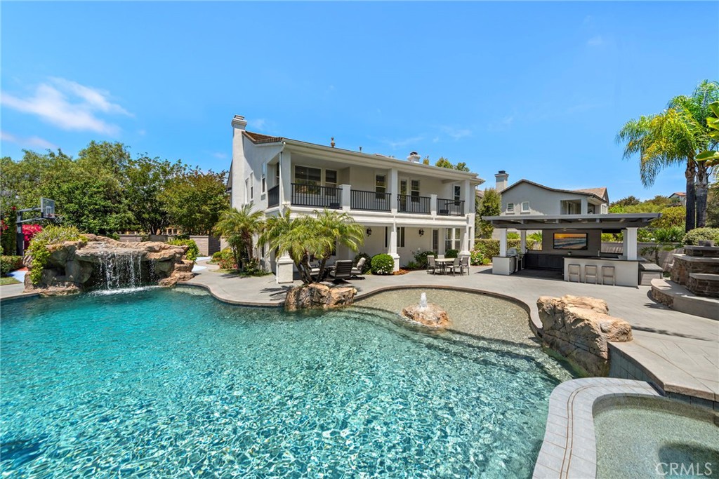 Welcome to 58 Long View in the prestigious South end of Coto de Caza. This remarkable single-family residence is a dream home in every sense, offering an upgraded living experience for discerning buyers of all types. With 5 bedrooms (one bedroom on the main floor with its own "En suite"), an additional dedicated office or exercise room, and 4.5 bathrooms, the home spans a generous 13,906 square foot lot—the second-largest in the neighborhood—providing ample privacy and open space.
As you step through the formal entry, you're greeted by elegant crown moldings and exquisite light fixtures, which give way to the graceful, curved archways of the living room. Central to this inviting space is a beautiful fireplace, surrounded by vaulted ceilings and large windows that bathe the room in warm sunlight. The house strikes a perfect balance between luxury and functionality, featuring a formal dining room for special occasions, a breakfast nook for casual dining, and island bar seating within the gourmet kitchen.
The chef’s dream kitchen doesn't hold back with high-end amenities, including a Sub-Zero refrigerator & Freezer, Wolf Range, Wolf Gourmet Microwave drawer, “True” built-in ice maker, Bosch dishwasher, Dacor warmer, and a walk-in pantry with an oversized wine fridge. Entertain guests in the family room with its elegant built-ins, surround sound speakers, and a cozy second fireplace.
The primary suite is a sanctuary of its own, featuring a double-sided fireplace (3rd Fireplace) and an oversized private balcony that overlooks your backyard and hillside views. The primary Bedroom has an additional living area, and a sumptuous bathroom featuring dual vanities, a step-in frameless shower, a standalone soaking tub, and a dressing-room-style closet.
Your private outdoor paradise dazzles with a pebble tech salt water pool with a baja shelf, waterfall, and spa. An outdoor fireplace, and a covered living area complete with Lynx BBQ, Lynx Fridge, Lynx Beer Tap, Bromic Heater, recessed lighting, ceiling fan, stone countertop that wraps around the outdoor covered living area, outdoor speaker system, and entertainment center. Basketball Sport court provides fun for an active lifestyle and family entertainment."
3 Car Garage with Additional storage cabinets, Overhead storage, and EV charger plug.
Experience a life of luxury, comfort, and endless enjoyment.