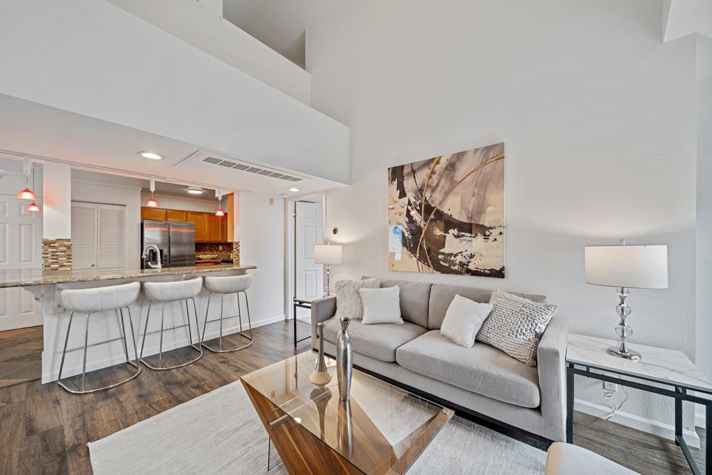 Discover this beautifully updated, light-filled 2-bed + loft, 2-bath condorarely on the market and move-in ready! Spanning approximately 1,257 sqft, the open layout ft. soaring ceilings, large windows, cozy fireplace, fresh paint & new ceiling fan in the living area. The refreshed kitchen boasts stainless steel appliances (including brand-new Samsung range), breakfast bar, and ample cabinetryideal for everyday meals or casual entertaining. Both spacious bedrooms are carpeted in luxury plush, and the primary suite offers a private en-suite bath. Upstairs, the versatile loft is perfect as a home office, guest space, or creative nook. Enjoy the convenience of in-unit LG washer/dryer, abundant storage, and a private patio with its own closet. Two dedicated parking spots in a secure garage add ease to your daily routine. Resort-style amenities include a hot tub and fitness room within a meticulously maintained complex. Located in the heart of South San Francisco, youre minutes from Trader Joes, Costco, the BART station, parks, dining, and the new community center and library. Major highways, schools, and shopping are all nearby. Dont miss this exceptional condo that blends comfort, style, and unbeatable convenience in one of South San Franciscos most desirable neighborhoods!