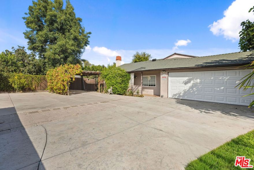 Updated Encino home on a private gated lot with an open floor plan! This beautifully updated property features a spacious living room with a cozy fireplace, a dining area with a wet bar, and an open kitchen with quartz countertops, stainless steel appliances, a deep sink, and soft-closing cabinetry. The primary suite boasts vaulted ceilings, a large walk-in closet, and sliding doors that open to the covered patio. The en-suite bathroom includes a dual vanity with quartz counters and a large walk-in shower. A second bedroom also features vaulted ceilings, a full bathroom, and ample storage. Enjoy your own private orchard with apple, pomegranate, citrus, grapes, and more! The low-maintenance yard includes a paved backyard, a covered patio, and a storage shed. Additional highlights include a two-car attached garage, covered parking, and space for multiple vehicles.