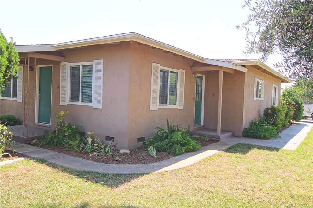 This unique home has been built around a center courtyard and is a must see to appreciate! The extra large living room has a beautiful stone fireplace, dual ceiling fans, newly refinished original wood flooring and double french doors leading to courtyard. Nicely updated kitchen includes new counter tops, updated cabinetry with built-in plate rack, built-in stainless steel dishwasher and gas range and double french doors that lead to center courtyard. Family room or eating area just off the kitchen has new carpet. Two good sized bedrooms with newly refinished original wood flooring and one with on-suite bath. Two updated bathrooms with tile bath/showers and a half bath with garage access. Garage partially converted to room but not being considered a 3rd bedroom. Large fully fenced lot with mature landscaping and fruit trees.