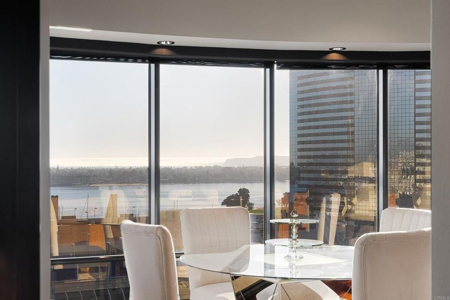 Perched high above the marina, this timeless Bubble Unit at the prestigious Harbor Club showcases sweeping views of San Diego Bay, the Coronado Bridge, and the downtown skyline. Ideally located near the Gaslamp Quarter, the residence offers convenient access to top dining, entertainment, and waterfront attractions. Two designated parking spaces provide added ease and accessibility.  This spacious two-bedroom, three-bathroom home features two private entrances and two expansive balconies that extend the living space and frame the home’s panoramic vistas. A built-in bar near one of the balconies creates a seamless indoor-outdoor experience—ideal for morning coffee or evening relaxation.  Elegant fixtures, recessed lighting, and abundant natural light enhance the sophisticated atmosphere throughout. The thoughtful floor plan includes two living areas, with one offering the flexibility to serve as an open-concept office. The generously sized kitchen and bathrooms offer ample counter space, complementing the home’s functionality and appeal for both everyday living and entertaining.  Located on a floor with only one neighboring residence, this home provides exceptional privacy. The primary bedroom suite, accessed through grand French doors, further elevates the sense of comfort and tranquility. The unit’s timeless design elements add to its enduring charm.  Residents of the Harbor Club enjoy resort-style amenities, including a pool, fitness center, and 24-hour security.  A rare offering in one of San Diego’s most iconic buildings, this Bubble Unit presents an exceptional opportunity to experience what San Diego is truly about.