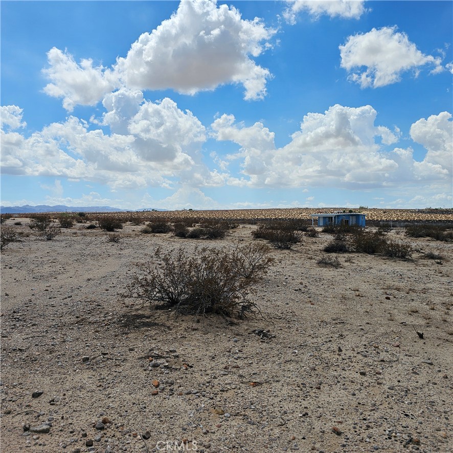 Nestled in the expansive desert landscape, this 5-acre parcel offers stunning panoramic views, pristine terrain and endless potential. Located just minutes away from the heart of 29 Palms, this property features wide open space with breath taking sunsets and star filled skies. If you want to be close to nature or Joshua Tree National Park, then this property is for you. Property being sold for land value only. Recreational cabin on the property is uninhabitable.
